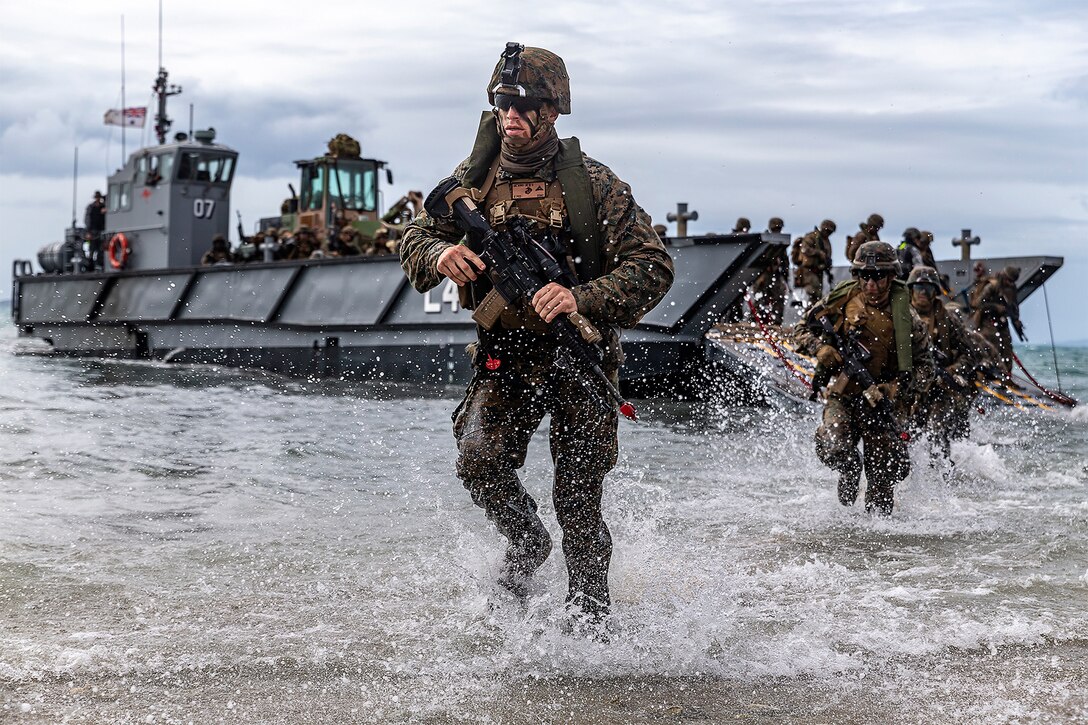 A Marine runs out of the ocean during an exercise.