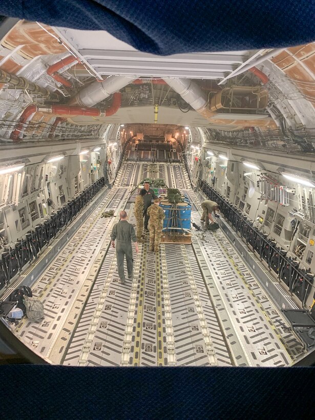 Capt. Gregory Firestone, 225th Air Defense Squadron air battle manager, observes the crew of a C-17 preparing for an airdrop during Exercise Rainier War June 26, 2019 at Joint Base Lewis-McChord.  Firestone is one of four air battle managers flying onboard the C-17s during the exercise in order to accomplish a portion of his training requirements to convert to a rated air battle manager.  (Courtesy Photo by Capt. Gregory Firestone)