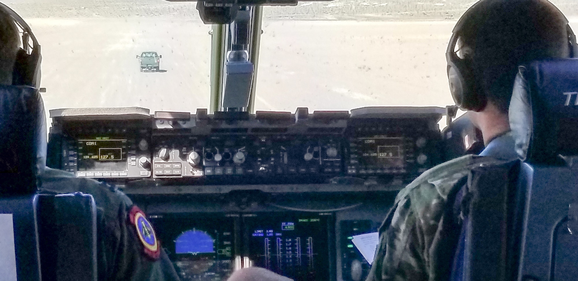 Maj. Dennis Martin, 225th Air Defense Squadron air battle manager, watches as the aircrew of the C-17 he is flying in during Exercise Rainier War taxis at Bicycle Lake Army Air Field near Fort Irwin, California, June 26, 2019.  Martin is one of four air battle managers flying onboard the C-17s during the exercise in order to accomplish a portion of his training requirements to convert to a rated air battle manager.  (Courtesy Photo by Maj. Dennis Martin)