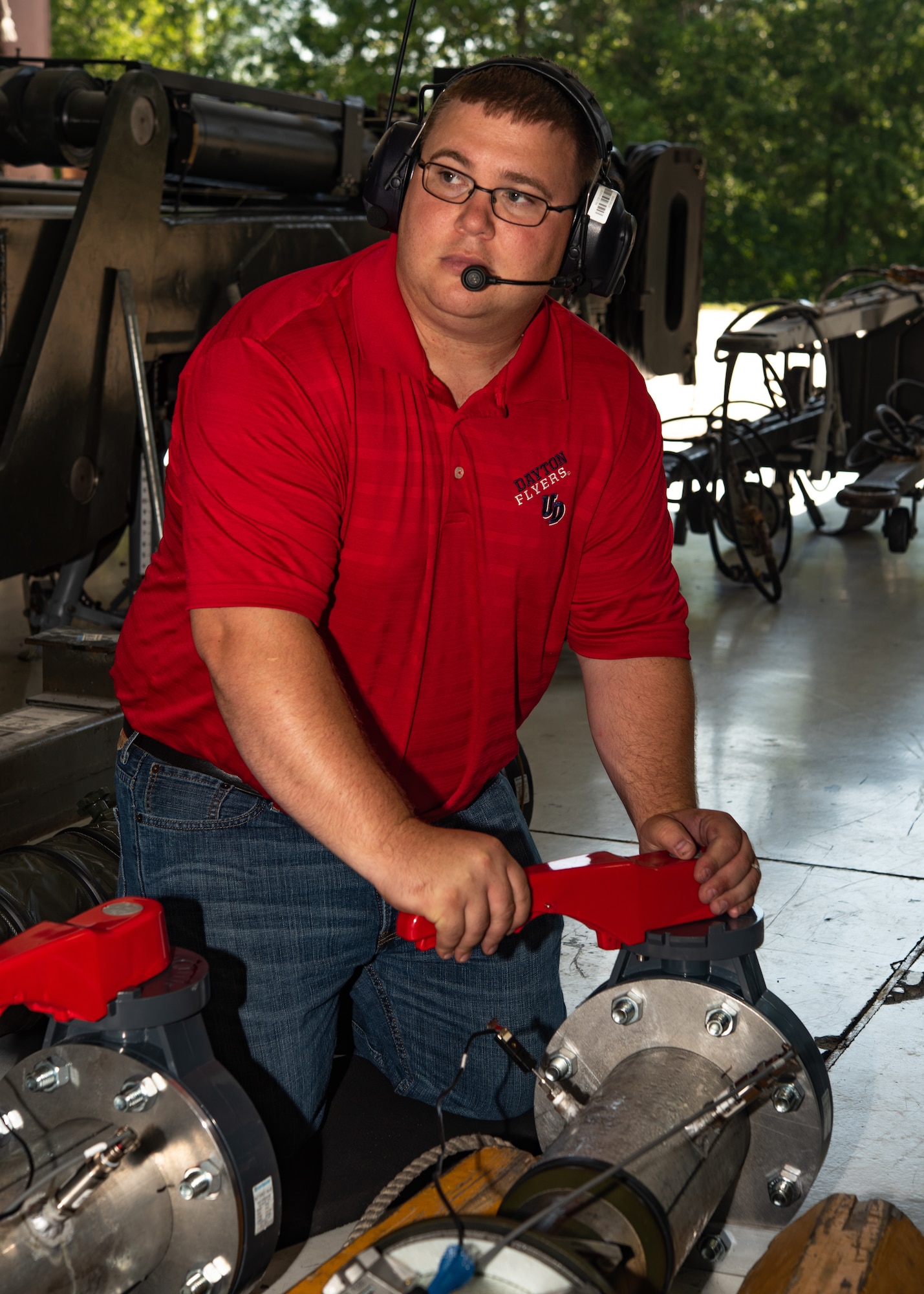 Alan Wendel, chief research technician, University of Dayton Research Institute, closes an air valve in order to create back pressure while testing a potential HVAC system for the B-2, on July 18, 2019, at Whiteman Air Force Base, Missouri. Whiteman AFB hosted seven organizations that include aircraft and equipment program offices, the Air Force Material Command, and the Air Force Research Lab to evaluate aircraft cooling options. (U.S. Air Force photo by Senior Airman Thomas Barley)
