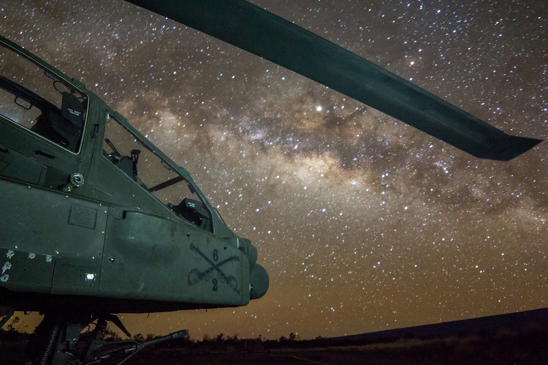 Army AH-64 Apache attack helicopter assigned to 2-6 Cavalry Regiment, 25th Combat Aviation Brigade, sits on flightline under night sky on FARP 17,
Pohakuloa Training Area, Island of Hawaii, Hawaii, April 13, 2019 (U.S. Army/Keith Kraker)