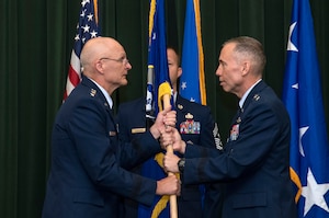 Maj. Gen. Tom Wilcox receives the unit flag from Gen. Arnold W. Bunch Jr., commander of Air Force Materiel Command, to become commander of the Air Force Installation and Mission Support Center July 25 during a ceremony at Joint Base San Antonio-Lackland. (U.S. Air Force photo by Johnny Saldivar)