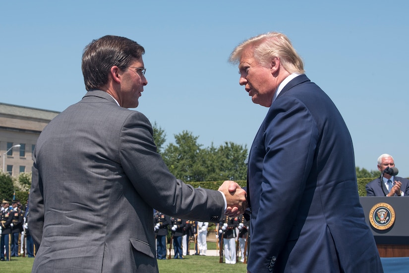 Defense secretary and president greet each other.