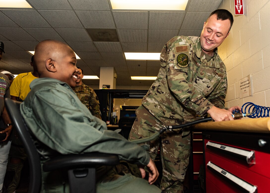 Tech. Sgt. Christopher Lineberry, quality assurance, 509th Operations Support Squadron, test an anti-gravity suit on Emil “Batman” Conley from Lee Summit, Missouri, during the Pilot for a Day tour on July 19, 2019, at Whiteman Air Force Base, Missouri. An anti-g suit is worn by aviators and astronauts who are subjected to high levels of accelerated force. Emil has medulloblastoma, which is the most common malignant brain tumor for children, and accounts for about 20 percent of all childhood brain tumors. Whiteman AFB collaborates with St. Jude Children’s Research Hospital to coordinate these tours. (U.S. Air Force photo by Senior Airman Thomas Barley)