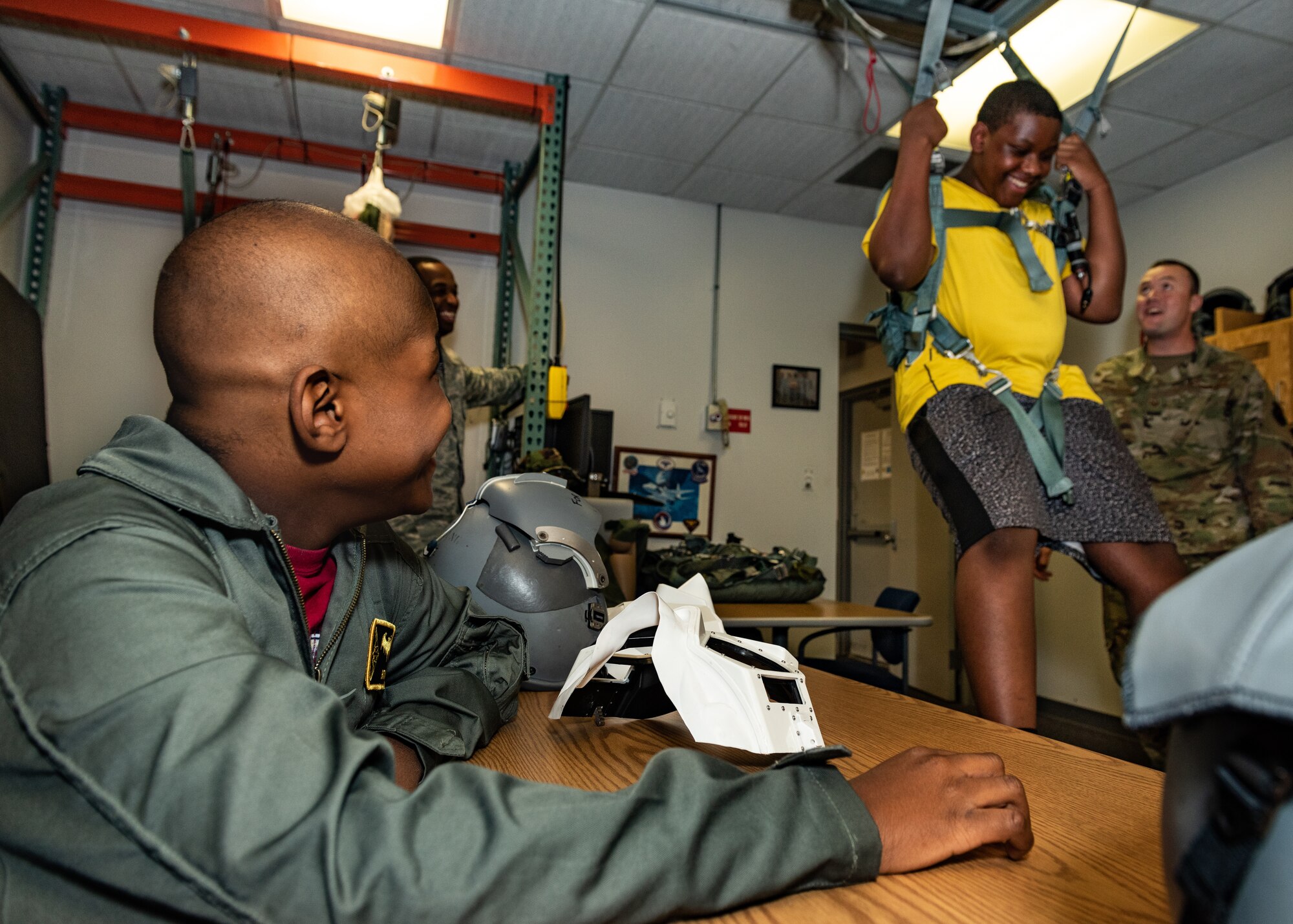 Emil “Batman” Conley from Lee Summit, Missouri, laughs at his brother, Manny Conley, as he tests the egress system during his Pilot for a Day tour on July 19, 2019, at Whiteman Air Force Base, Missouri. Aircrew Flight Equipment specialist perform maintenance and coordination of seats, hatches, canopies and modules, to ensure that pilots can make a safe escape in case of emergency. Emil has medulloblastoma, which is the most common malignant brain tumor for children, and accounts for about 20 percent of all childhood brain tumors. Whiteman AFB collaborates with St. Jude Children’s Research Hospital to coordinate these tours. (U.S. Air Force photo by Senior Airman Thomas Barley)