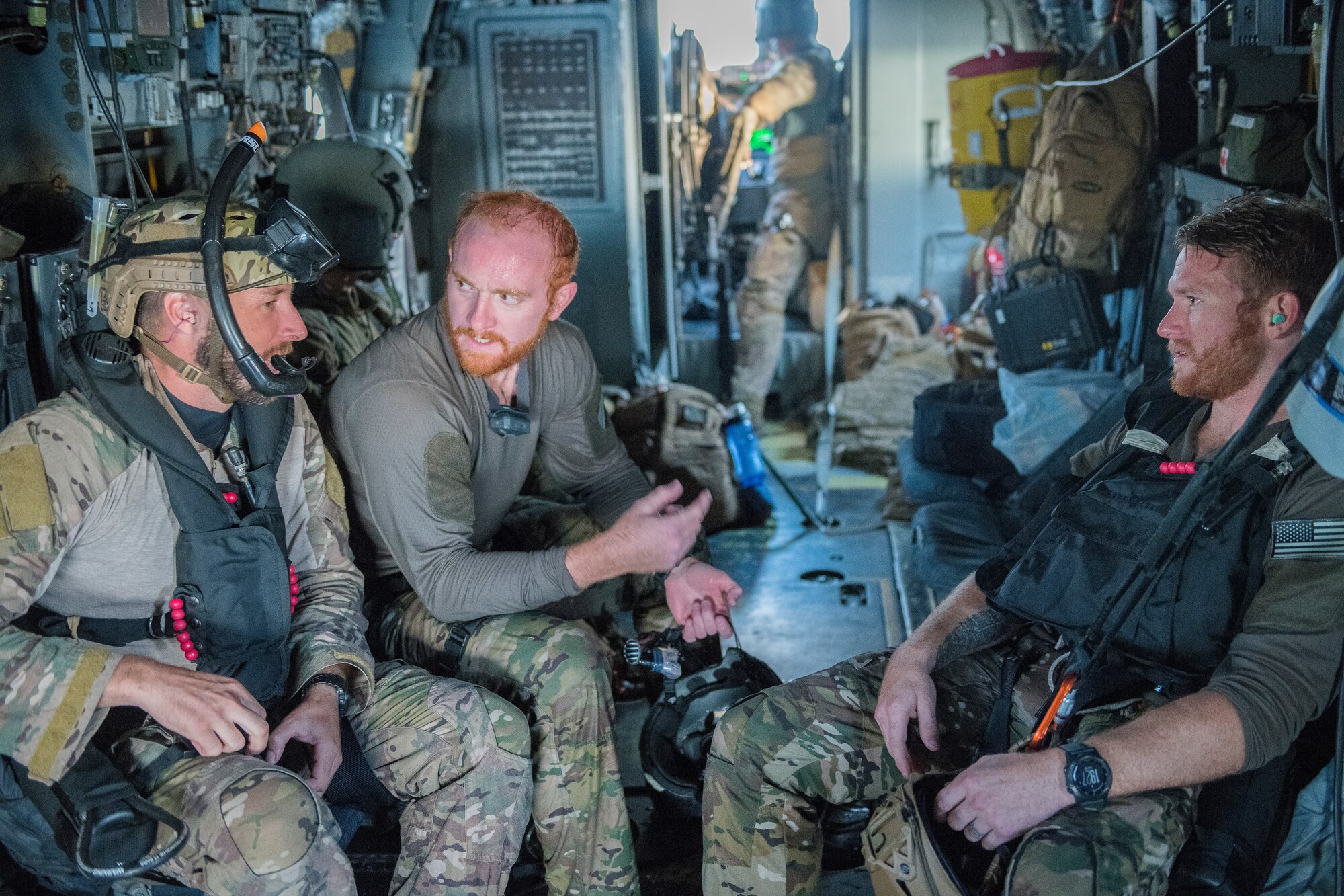 Pararescuemen from the 26th Special Tactics Squadron speak amongst themselves after a training exercise at Ute Lake, N.M., July 23, 2019. The members performed training during the day and night, to test their rescue capabilities under different environmental circumstances. (U.S. Air Force photo by Senior Airman Vernon R. Walter III)