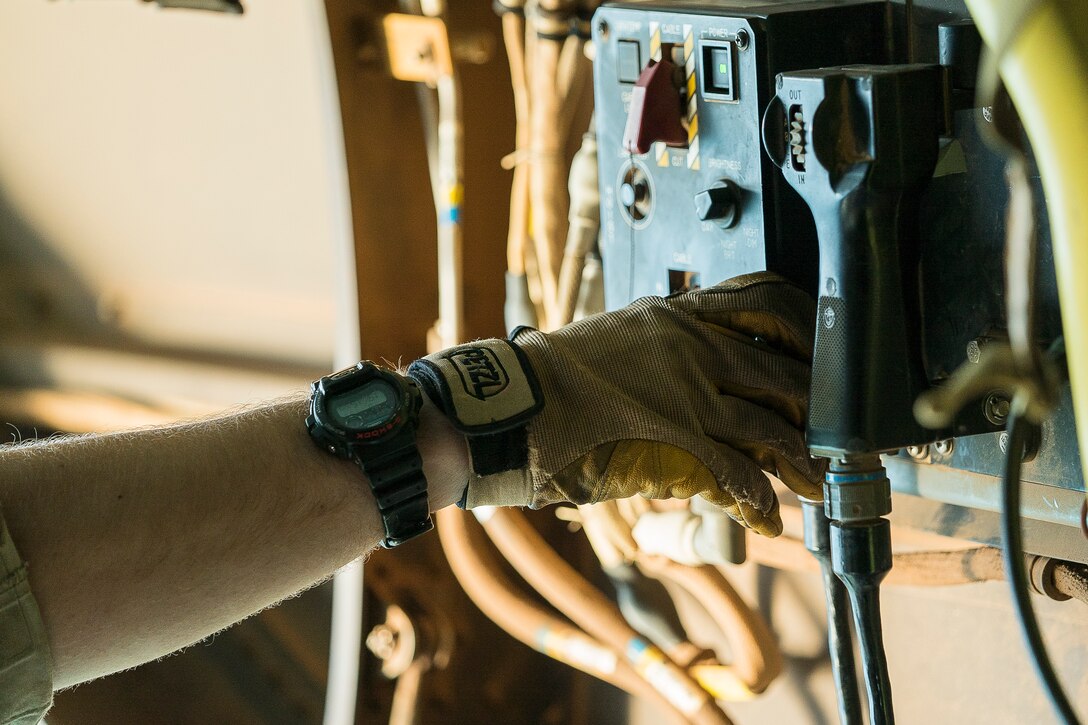 Senior Airman Jacob Bland, 20th Special Operations Squadron lead flight engineer, operates a winch to lift members of the 26th Special Tactics from Ute Lake, N.M., July 23, 2019. The members performed both day and night operation training during the day and night, to test capabilities under difficult environmental circumstances. (U.S. Air Force photo by Senior Airman Vernon R. Walter III)