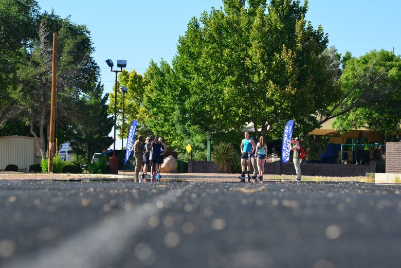 Participants, hosts and spectators in the Fastest Athletes on Base Track Meet gather at the finish line.