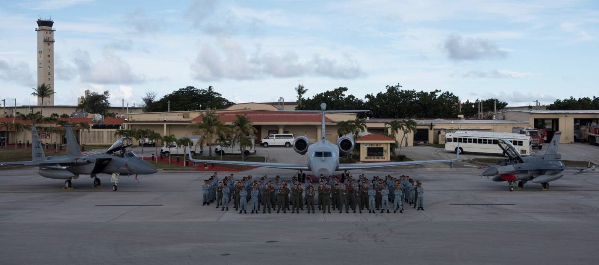 Republic of Singapore Air Force personnel stand in front of (from left to right) an F-15C Eagle from the 122nd Fighter Squadron from the 159th Fighter Wing of the New Orleans Air National Guard, Louisiana, and an RSAF G550 Airborne Early Warning aircraft and an RSAF F-16 at Andersen Air Force Base, Guam, July 9, 2019.