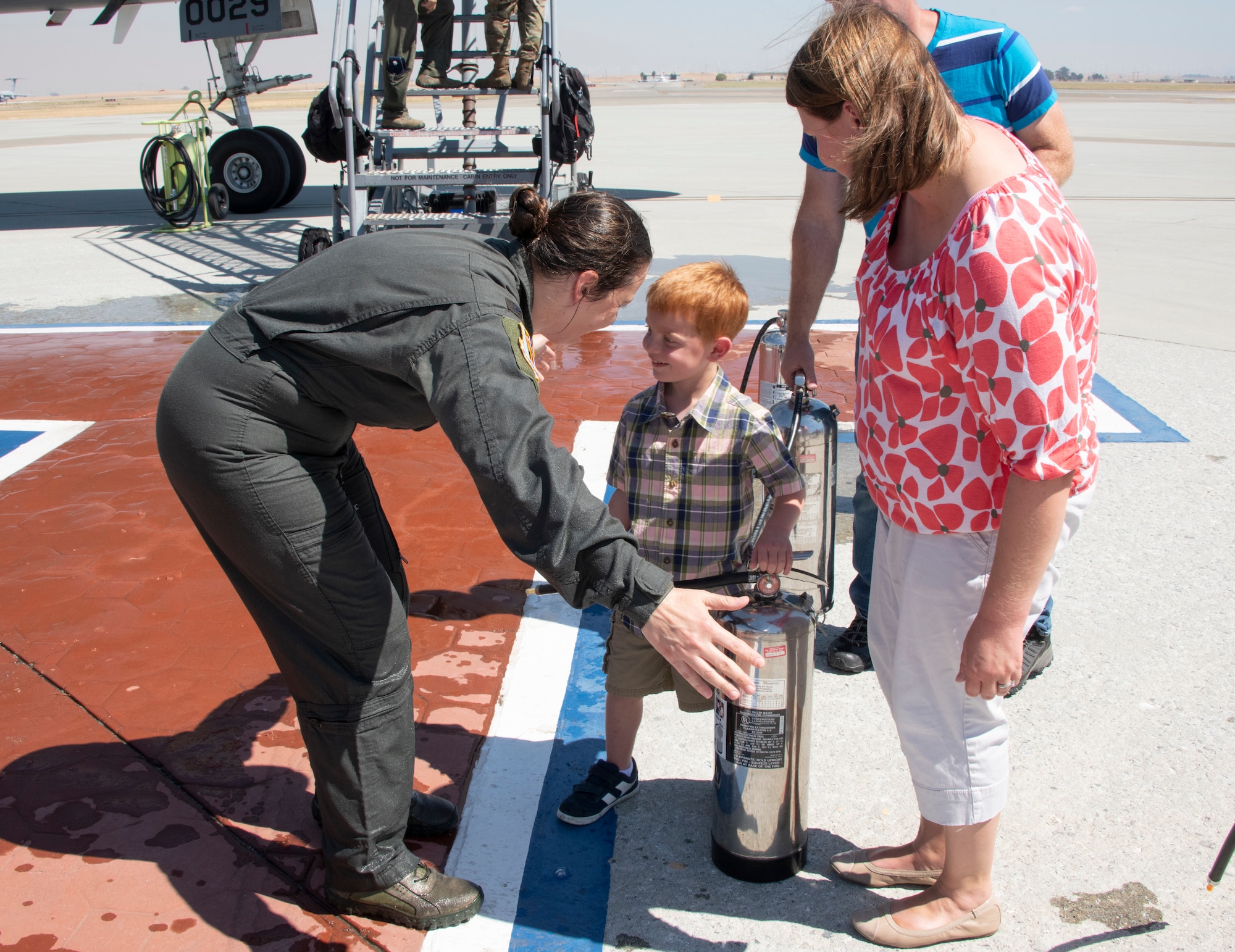 U.S. Air Force Col. Theresa Weems, 60th Operations Group commander, greets family after her final flight at Travis Air Force Base, California, July 24, 2019. Fini-flights are a traditional way to mark milestones in the career of aircrew, respected individuals of rank or repute, or a commander's departure to another command. Weems has served as the commander for the 60th OG for the largest air mobility wing in the Air Force since July 2017. (U.S. Air Force photo by Heide Couch)