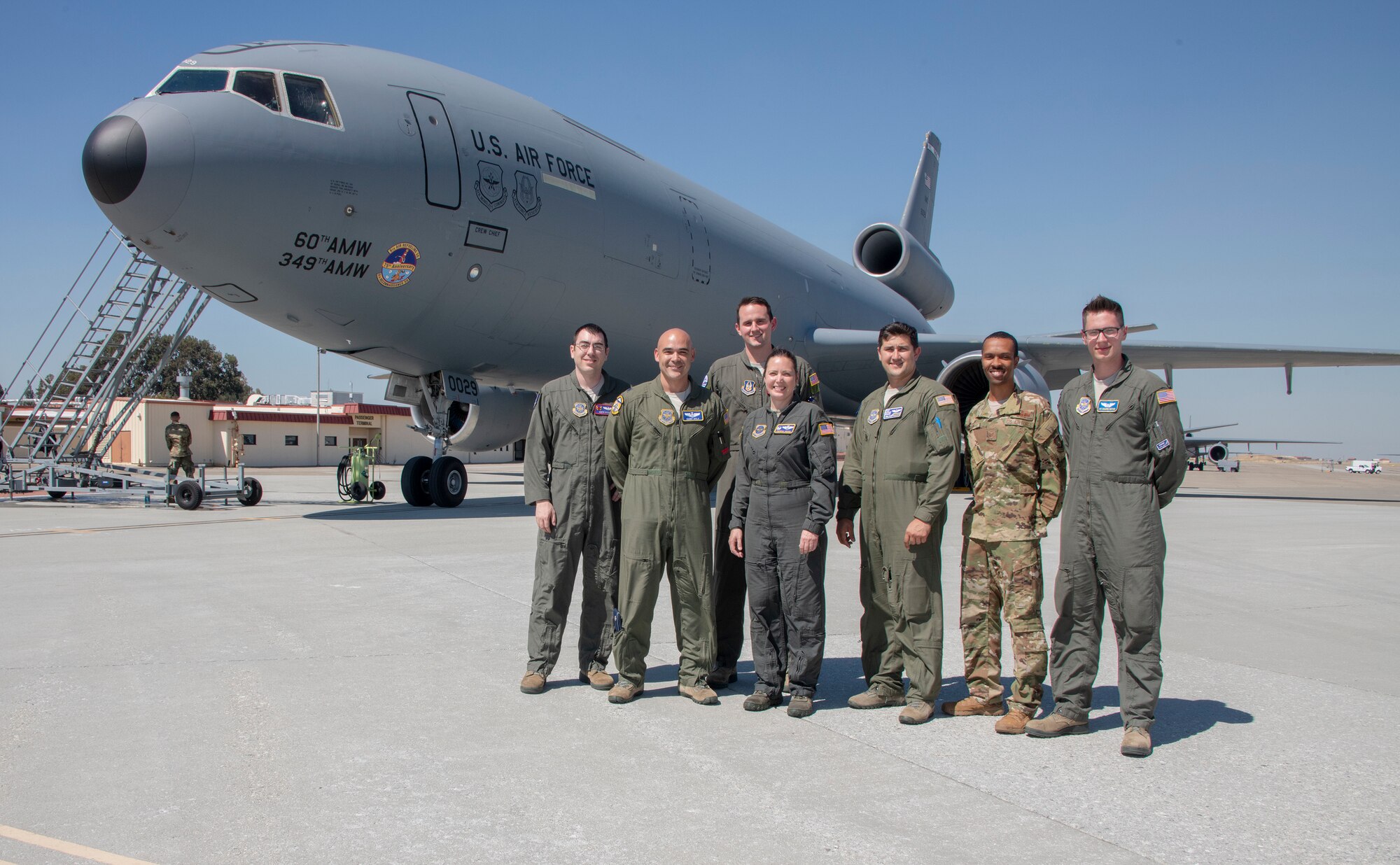 U.S. Air Force Col. Theresa Weems, 60th Operations Group commander, center, poses with other Airmen from the 60th OG after her final flight, July 24, 2019, at Travis Air Force Base, California. Fini-flights are a traditional way to mark milestones in the career of aircrew, respected individuals of rank or repute, or a commander's departure to another command. Weems has served as the commander for the 60th OG for the largest air mobility wing in the Air Force since July 2017. (U.S. Air Force photo by Heide Couch)
