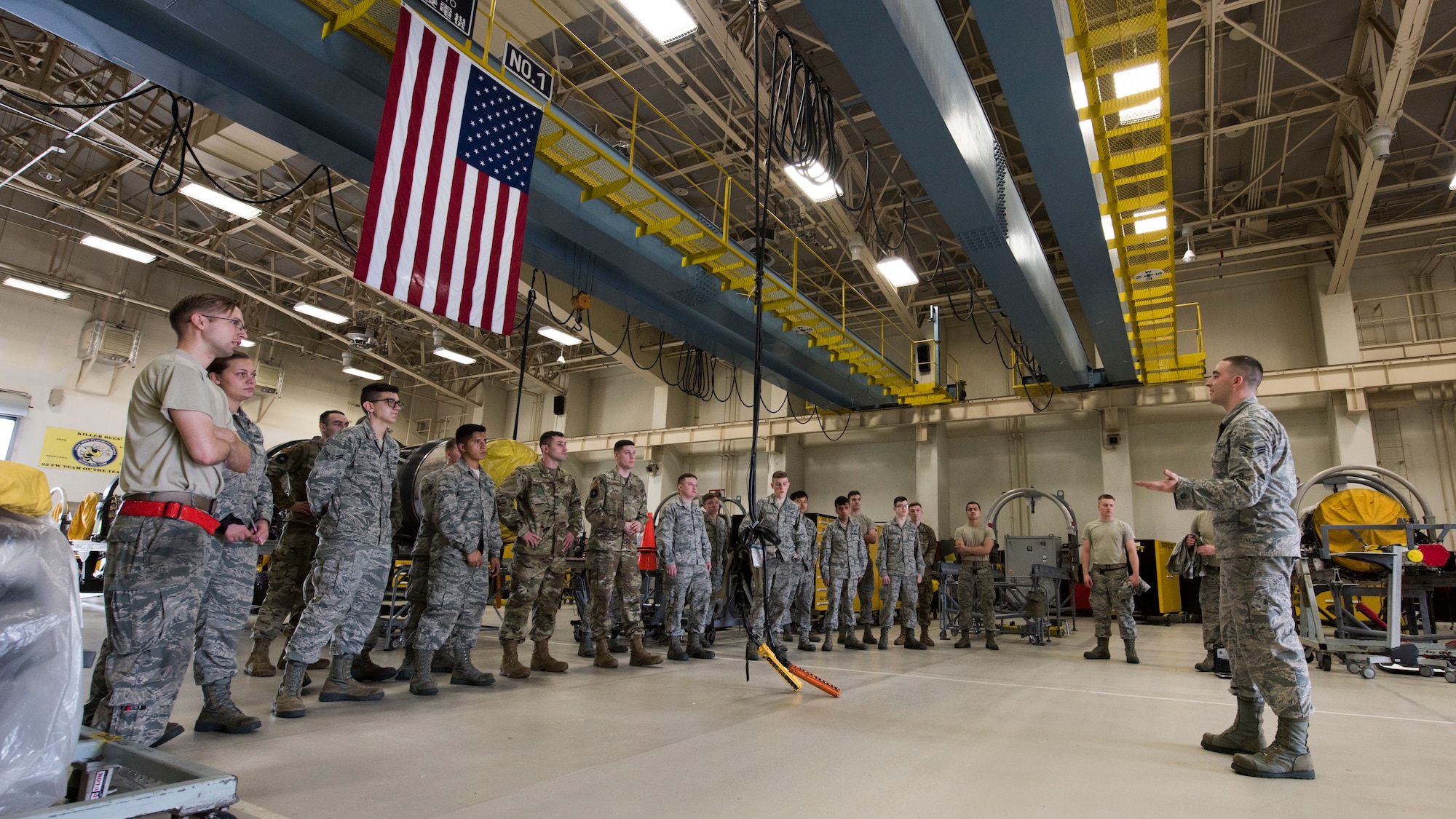 U.S. Air Force Senior Airman Taylor Reineke, a 35th Maintenance Squadron aerospace propulsions journeyman, speaks with his fellow wingmen on operational safety and rules at Misawa Air Base, Japan, July 16, 2019. The shop implemented continuous process improvements, such as a new storage facility, to maximize daily operation capabilities by providing space, storage and convenience needed. This aided in a team best of engines serviced in a month since 2006. (U.S. Air Force photo by Senior Airman Collette Brooks)