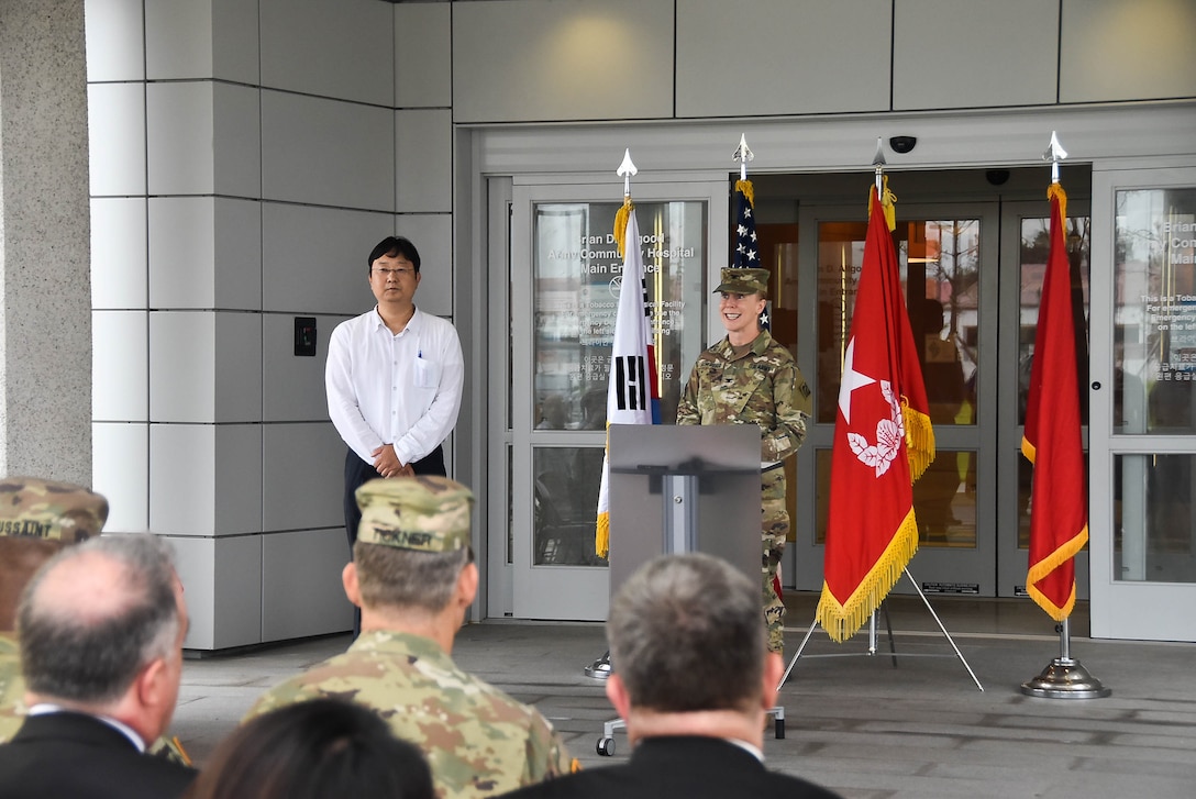 Brig. Thomas Tickner (center), U.S. Army Corps of Engineers (USACE), Pacific Ocean Division commander, and dignitaries gather in front of the new Brian D. Allgood Army Community Hospital, following the signing of the Acceptance Release Letter, Camp Humphreys, South Korea, July 24. (Photos by Antwaun J. Parrish)