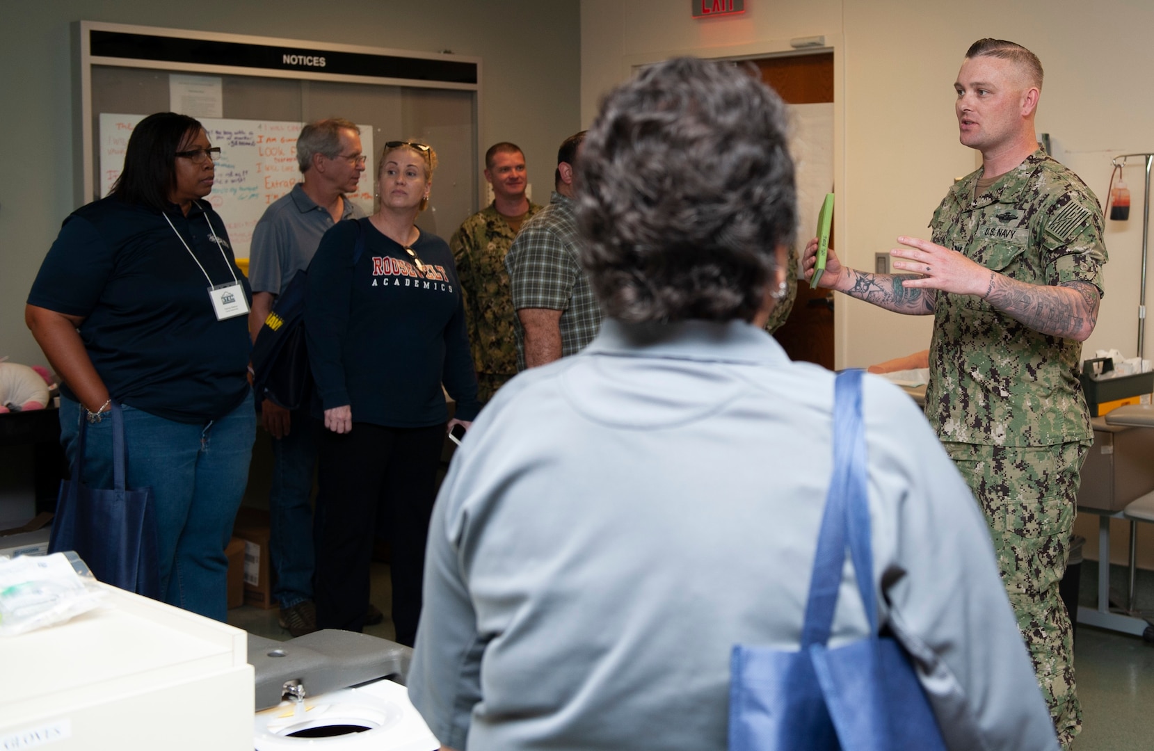 Petty Officer 1st Class Justin Moore, an instructor with the Hospital Corpsman Basic program at the Medical Education and Training Campus at Joint Base San Antonio-Fort Sam Houston, speaks to a group of San Antonio middle and high school educators during a tour of the campus. The tour provided educators and counselors a general overview of the medical career fields offered in the Navy in an effort to raise awareness of Navy career opportunities.