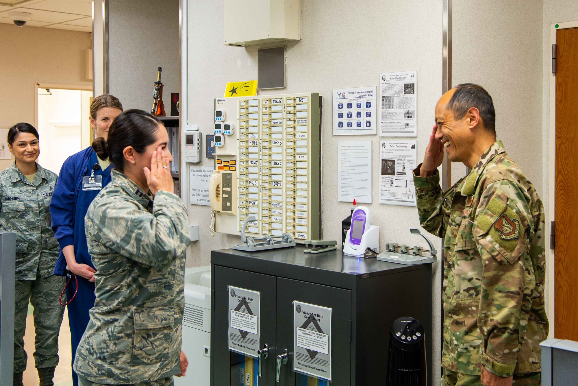 Capt. Victoria Flores-Sahagun, a clinical nurse at the Multi Service Inpatient Unit, salutes Col. Rudolph Cachuela, Pacific Air Forces Command Surgeon, after being coined for her outstanding service as a member of the Multi Service Inpatient Unit in the 374th Medical Group on Yokota AB, Japan, July 23, 2019. Cachuela visited the 374th Medical Group to get face-to-face time with the personnel and recognize outstanding performers.