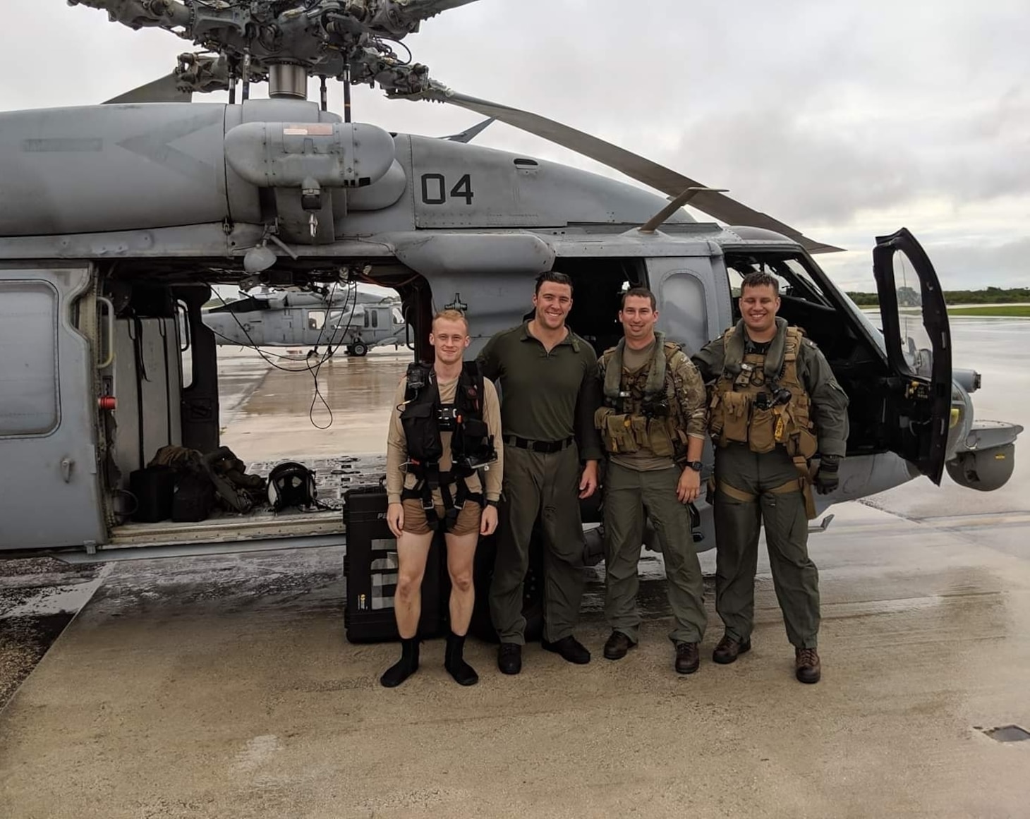 Naval Air Crewman (Helicopter) 2nd Class Preston Smith, from Stevens Point, Wisconsin, Naval Air Crewman (Helicopter) 2nd Class Dominic Thomas, from Menominee Falls, Wisconsin, LT Nathan Gordon, from Marietta, Georgia, and LTJG Caleb French from, Amherst, Wisconsin, pose for a photograph after completing a search and rescue mission as part of “Island Knights” of Helicopter Sea Combat Squadron (HSC) 25. HSC-25 provides a multi-mission rotary wing capability for units in the U.S. 7th Fleet area of operations and maintains a Guam-based 24-hour search-and-rescue and medical evacuation capability, directly supporting U.S. Coast Guard and Joint Region Marianas. HSC-25 is the Navy’s only forward-deployed MH-60S expeditionary squadron.