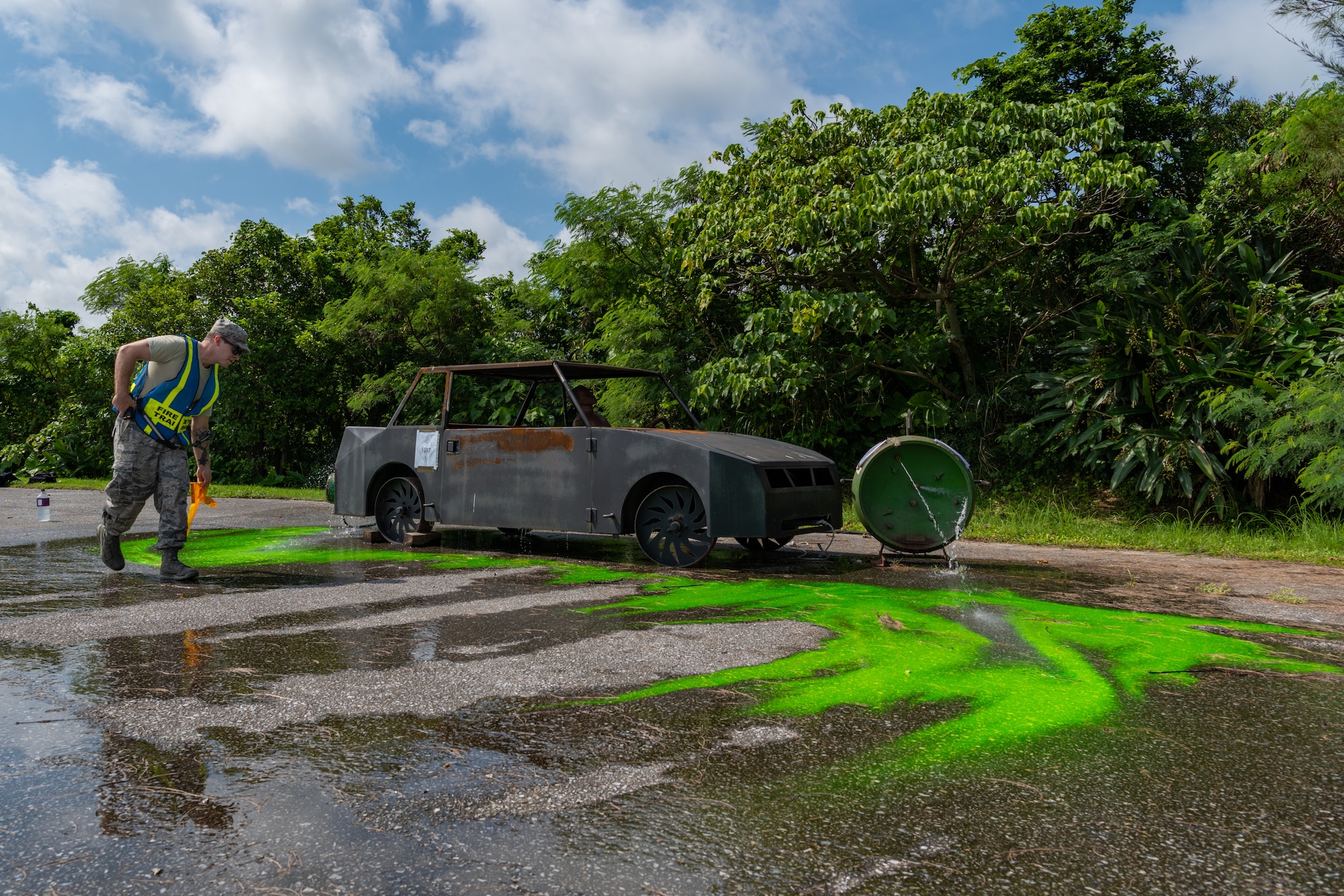 U.S. Air Force Staff Sgt. Ryan Oke, fire emergency services training lead assigned to the 18th Civil Engineer Squadron, spreads green dye to simulate a hazardous chemical during a hazardous material training exercise July 11, 2019, on Kadena Air Base, Japan. The main objective of the HazMat training is for firefighters to familiarize themselves with hazardous materials and prevent them from spreading. (U.S. Air Force photo by Senior Airman Cynthia Belío)