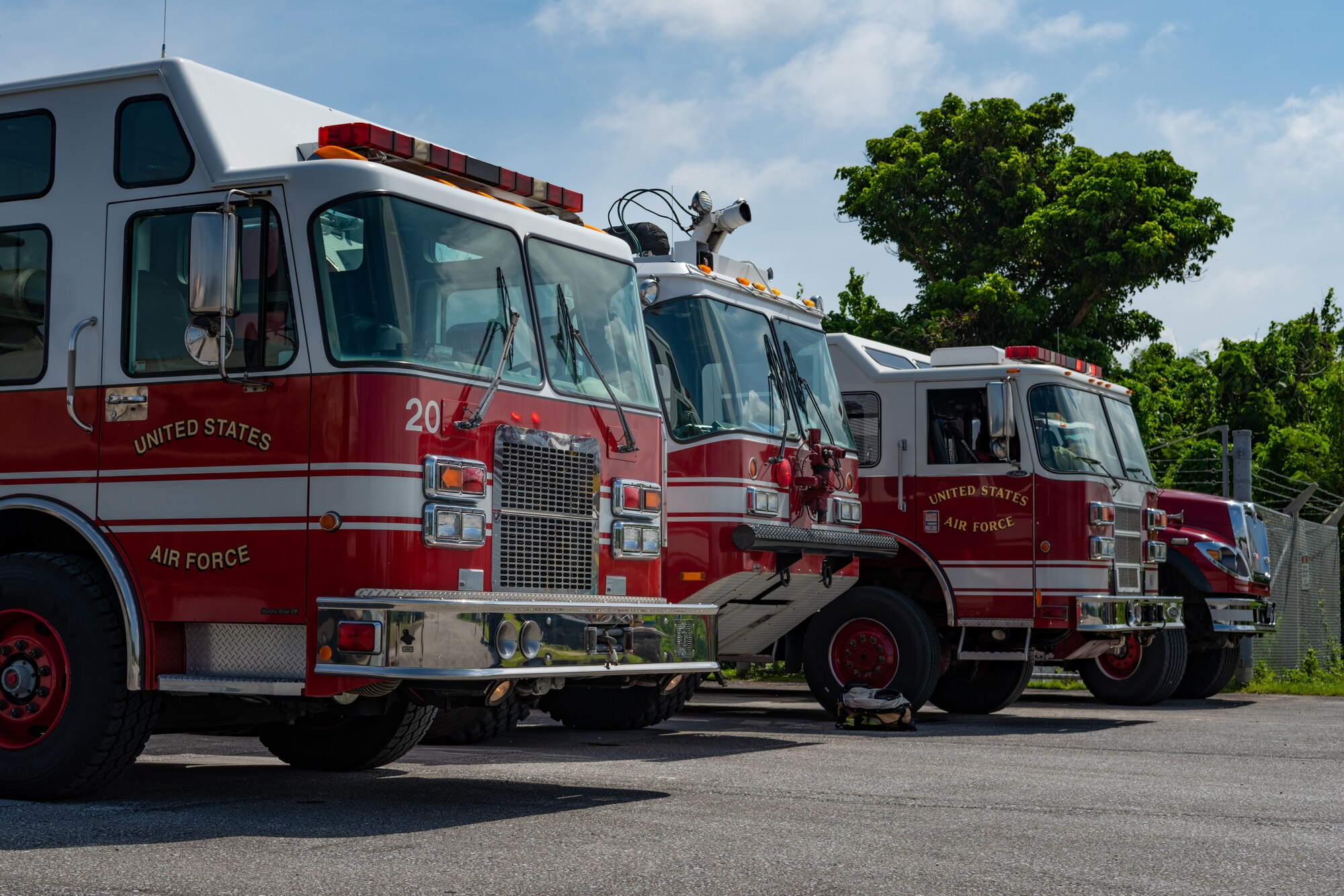 Fire department vehicles assigned to the 18th Civil Engineer Squadron standby on a safe site near a simulated chemical spill during a hazardous material training exercise July 11, 2019, on Kadena Air Base, Japan. The main objective of the HazMat training is for firefighters to familiarize themselves with hazardous materials and prevent them from spreading. (U.S. Air Force photo by Senior Airman Cynthia Belío)