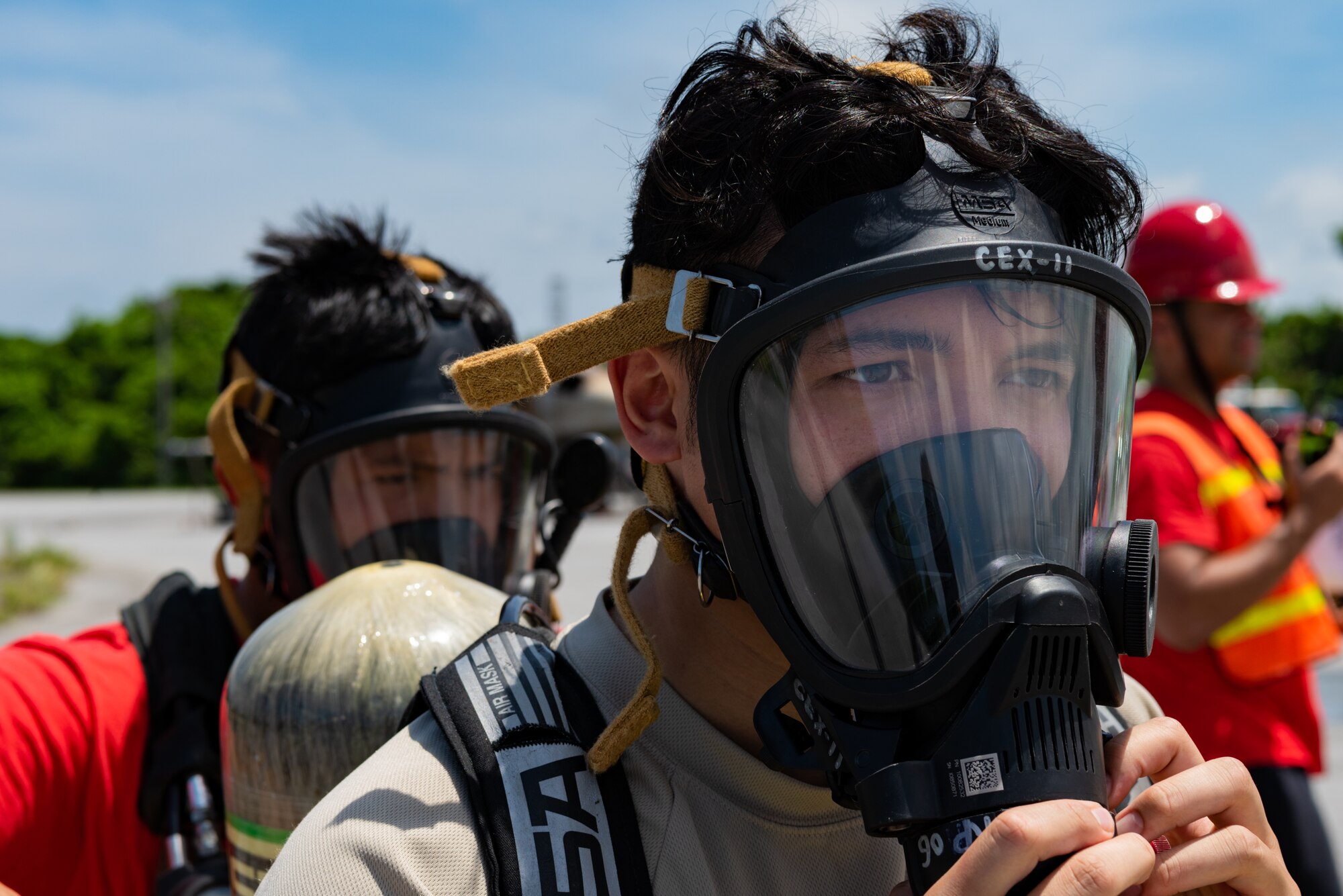 U.S. Air Force Senior Airman Sean Kientz, emergency management journeyman assigned to the 18th Civil Engineer Squadron, tests a self-contained breathing apparatus during a hazardous material training exercise July 11, 2019, on Kadena Air Base, Japan. The Level A suit worn during this training provides the highest level of protection against direct and airborne chemical contact, and is often worn with a self-contained breathing apparatus. (U.S. Air Force photo by Senior Airman Cynthia Belío)