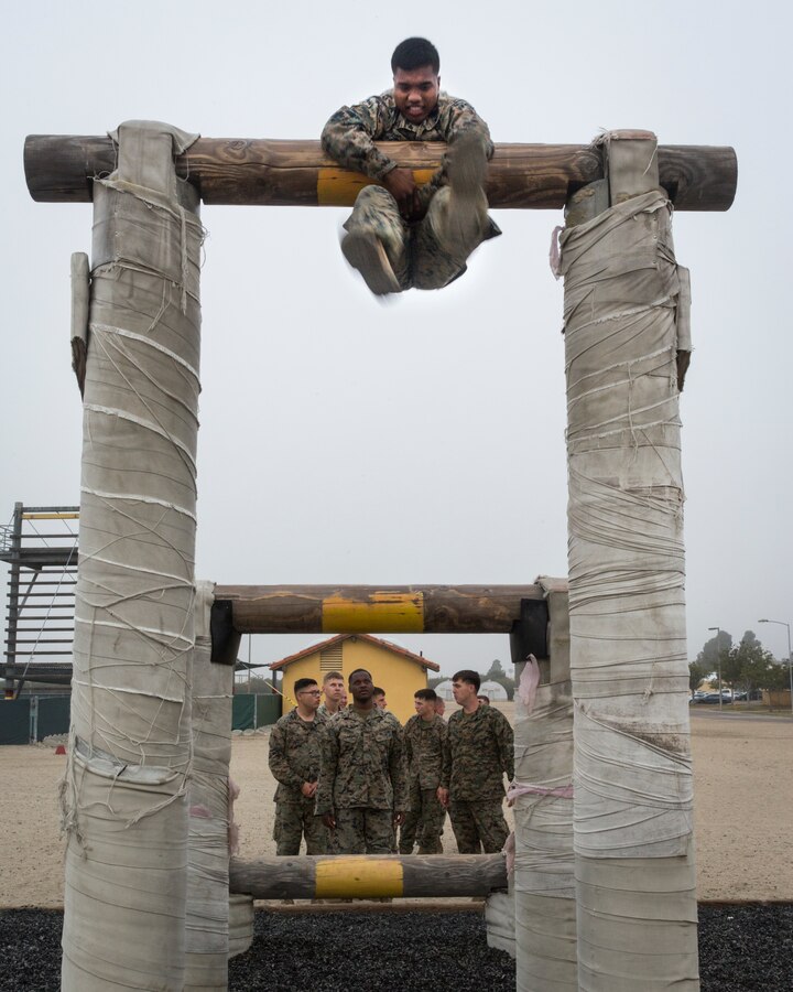U.S. Marine Corps Lance Cpl. Derek Lazarus, an electrician with Combat Service Support Company (CSSC), I Marine Expeditionary Force Support Battalion, wraps himself around a log during a team building event at Marine Corps Recruit Depot (MCRD) San Diego, California, June 11, 2019. CSSC visited MCRD San Diego to partake in team building events such as the confidence course, a visit to the museum, and briefs from the drill instructor and recruiter's schools to learn more about potential career opportunities. (U.S. Marine Corps photo by Cpl. Danny Gonzalez)