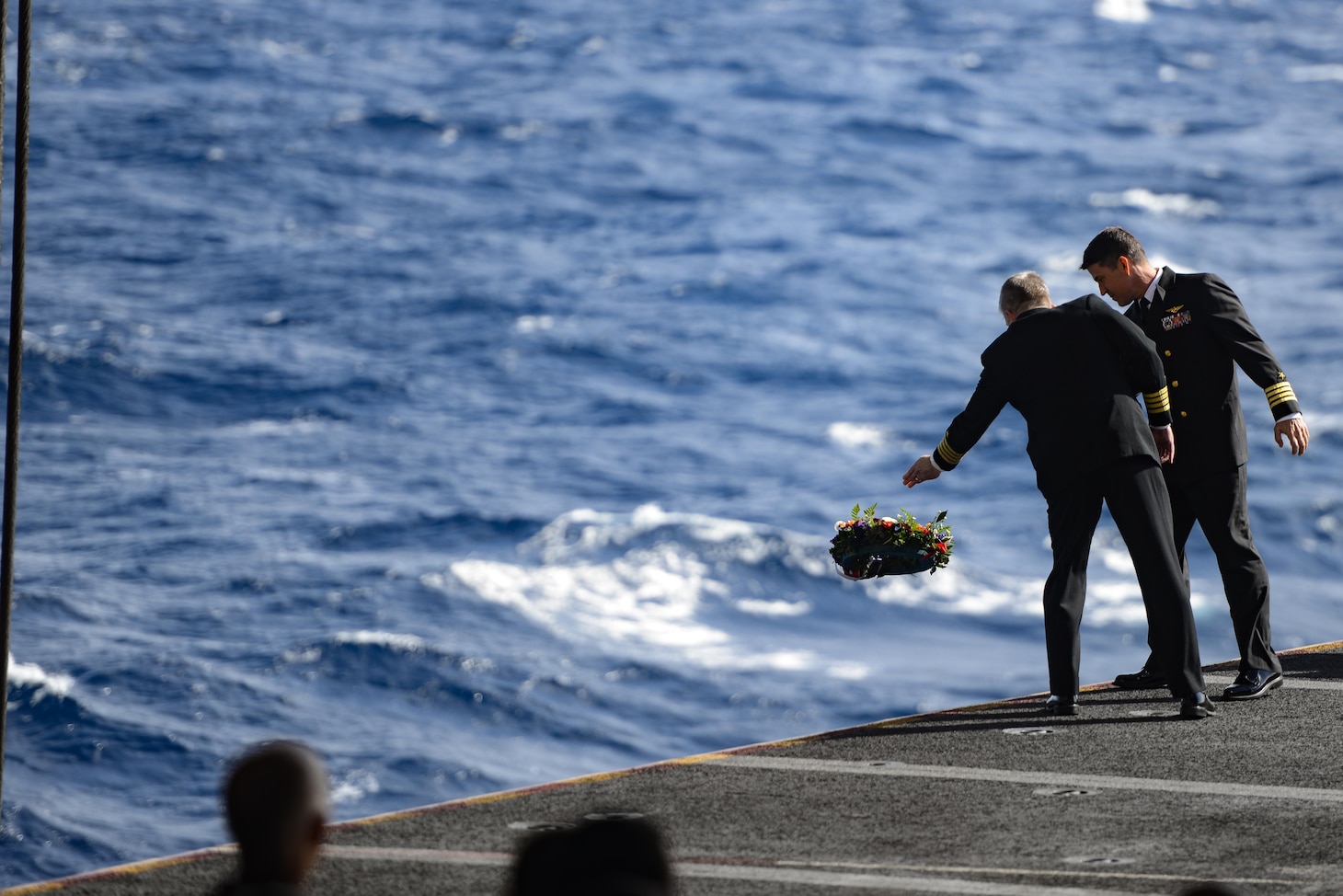 CORAL SEA (July 26, 2019) – Capt. Pat Hannifin, commanding officer of the Navy’s forward-deployed aircraft carrier USS Ronald Reagan (CVN 76), and Capt. Forrest Young, commanding officer of Carrier Air Wing (CVW) 5, lay a wreath into the Coral Sea during a remembrance ceremony for USS Lexington (CV 2). Ronald Reagan is the first aircraft carrier to commemorate Lexington since the discovery of the wreckage in 2018. Ronald Reagan, the flagship of Carrier Strike Group 5, provides a combat-ready force that protects and defends the collective maritime interests of its allies and partners in the Indo-Pacific region.