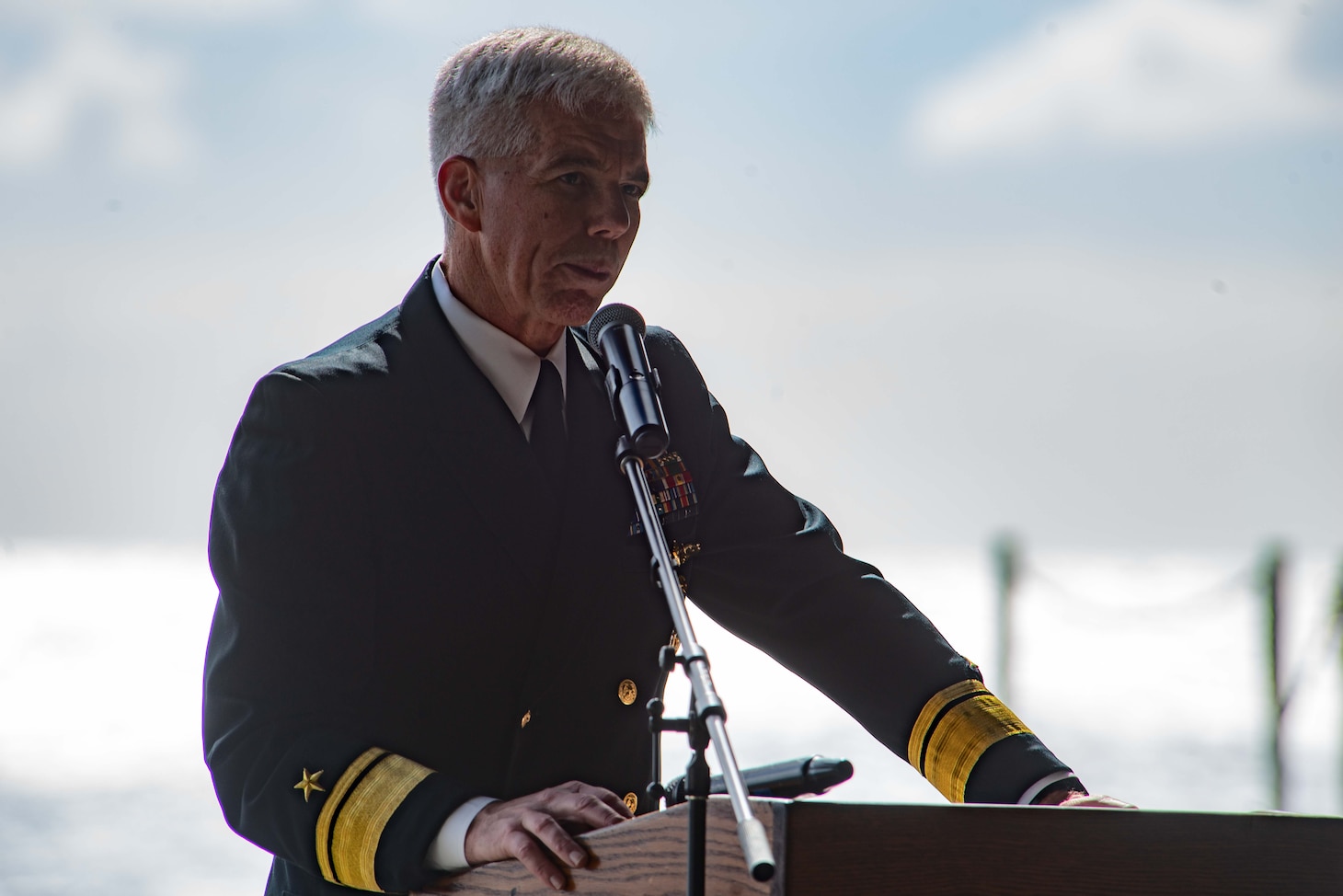 CORAL SEA (July 26, 2019) Rear Adm. Karl Thomas, Commander, Task Force 70, speaks in the hangar bay aboard the Navy’s forward-deployed aircraft carrier USS Ronald Reagan (CVN 76) during a remembrance ceremony for USS Lexington (CV 2). Ronald Reagan is the first aircraft carrier to commemorate Lexington since the discovery of the wreckage in 2018. Ronald Reagan, the flagship of Carrier Strike Group 5, provides a combat-ready force that protects and defends the collective maritime interests of its allies and partners in the Indo-Pacific region.