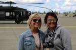 Melissa Boudreau, right, Career and Technical Education director and Denise Prescott, administrative assistant from Kelso High School pose with a Black Hawk helicopter at Grays Army Airfield, Joint Base Lewis-McChord, Wash., on June 24, 2019. The ride was part of an educator lift conducted by the Washington Army National Guard’s Recruiting and Retention Battalion. The purpose of the event is to educate attendees on the Washington National Guard’s benefits and programs.