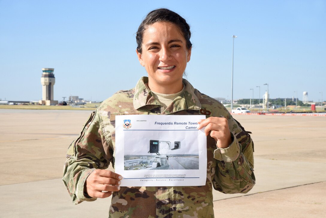 Headquarters Air Force Flight Standards Agency Airfield Operations Requirements Manager Capt. Liliana Urrego shows a photo of what the remote tower cameras in front of Tinker Air Force Base's new tower, in its final phase of construction. Urrego will evaluate the assessment at Homestead in 2020 to help determine if the remote tower cameras are a beneficial alternative to brick and mortar towers. (U.S. Air Force photo/Kelly White)