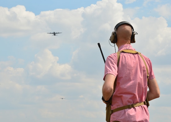 U.S. Air Force Capt. Jacob Kopp, 435th Contingency Response Squadron landing zone safety officer, watches U.S. Air Force C-130J Super Hercules flying over a landing zone at Powidz Air Base, Poland. During Aviation Rotation 19-3, a bilateral exercise between U.S. and Poland, landing and drop zones were prepared by members of the 435th CRS to allow pilots a diverse training opportunity. (U.S. Air Force photo by Staff Sgt. Jimmie D. Pike)