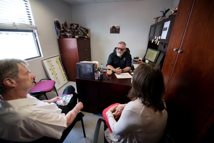 Professor Robert Klesges (left), Jerry Britt, 341st Training Squadron adoptions and dispositions coordinator, and Melissa Little, 59th Medical Wing behavioral health preventive medicine researcher, talk about the military working dog (MDW) adoption process June 26, 2019, at Joint Base San Antonio, Texas.