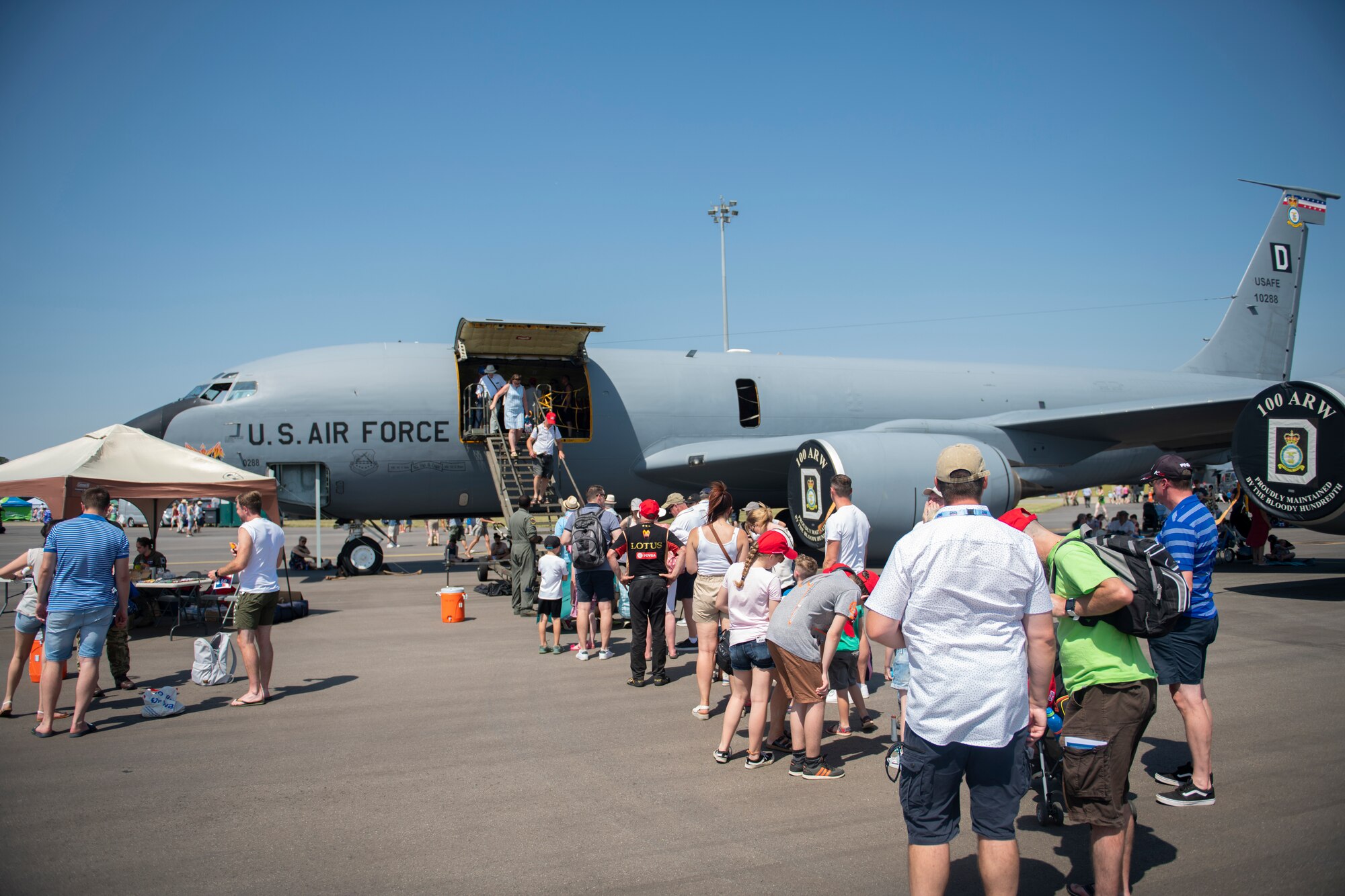 Families wait to receive a tour of a KC-135 Stratotanker from the 100th Air Refueling Wing during Families and Friends Day at RAF Marham, England July 25, 2019. Static displays for the event included a KC-135 Stratotanker from the 100th ARW, a CV-22 Osprey from the 352d Special Operations Wing and two F-15E Strike Eagles from the 48th Fighter Wing. (U.S. Air Force photo by Tech. Sgt. Emerson Nuñez)