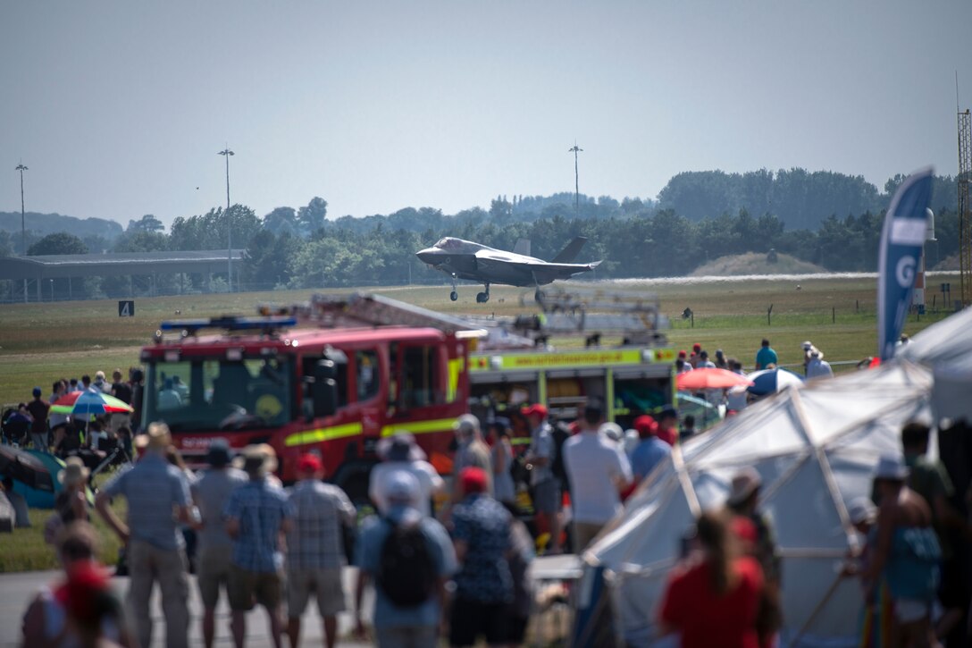 Spectators view an F-35B Lightning II land during the Families and Friends Day at RAF Marham, England, July 25, 2019. The day is all about saying "thank you," to the RAF personnel's families and friends in the local community who support the installation. (U.S. Air Force photo by Tech. Sgt. Emerson Nuñez)