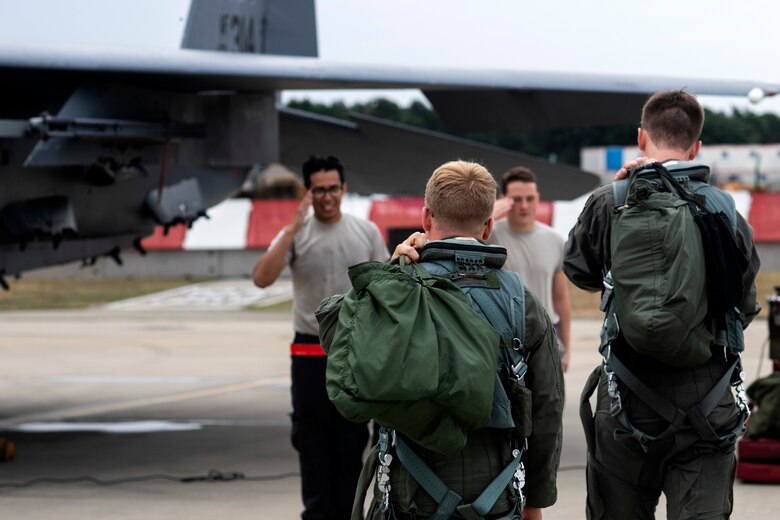 A pilot assigned to the 492nd Fighter Squadron and a U.S. Air Force Academy cadet approach an F-15E Strike Eagle at Royal Air Force Lakenheath, England, July 26. The cadets are participating in “Operation Air Force,” a two-week program in which they are able to see and experience the Air Force mission being accomplished first-hand. (U.S. Air Force photo by Senior Airman Malcolm Mayfield)