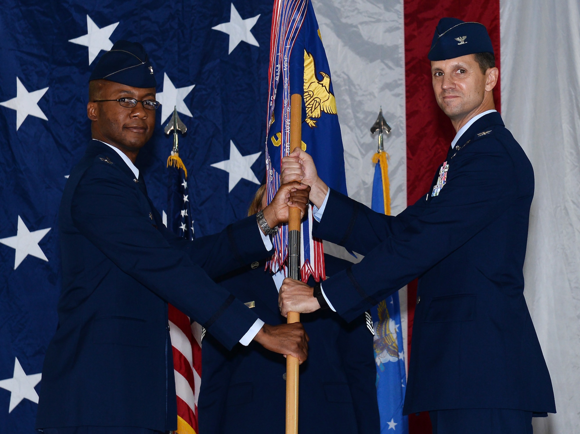 Col. Gavin Marks, 55th Wing commander, passes the 55th Mission Support Group guidon to Col. W.R. Alan Dayton, during the 55th Mission Support Group Change of Command ceremony July 24, 2019, inside the Offutt Air Force Base Fire Station. Col. W.R. Alan Dayton took over command of the 55th MSG from Col. J. David Norton who has served in the position since 2017.