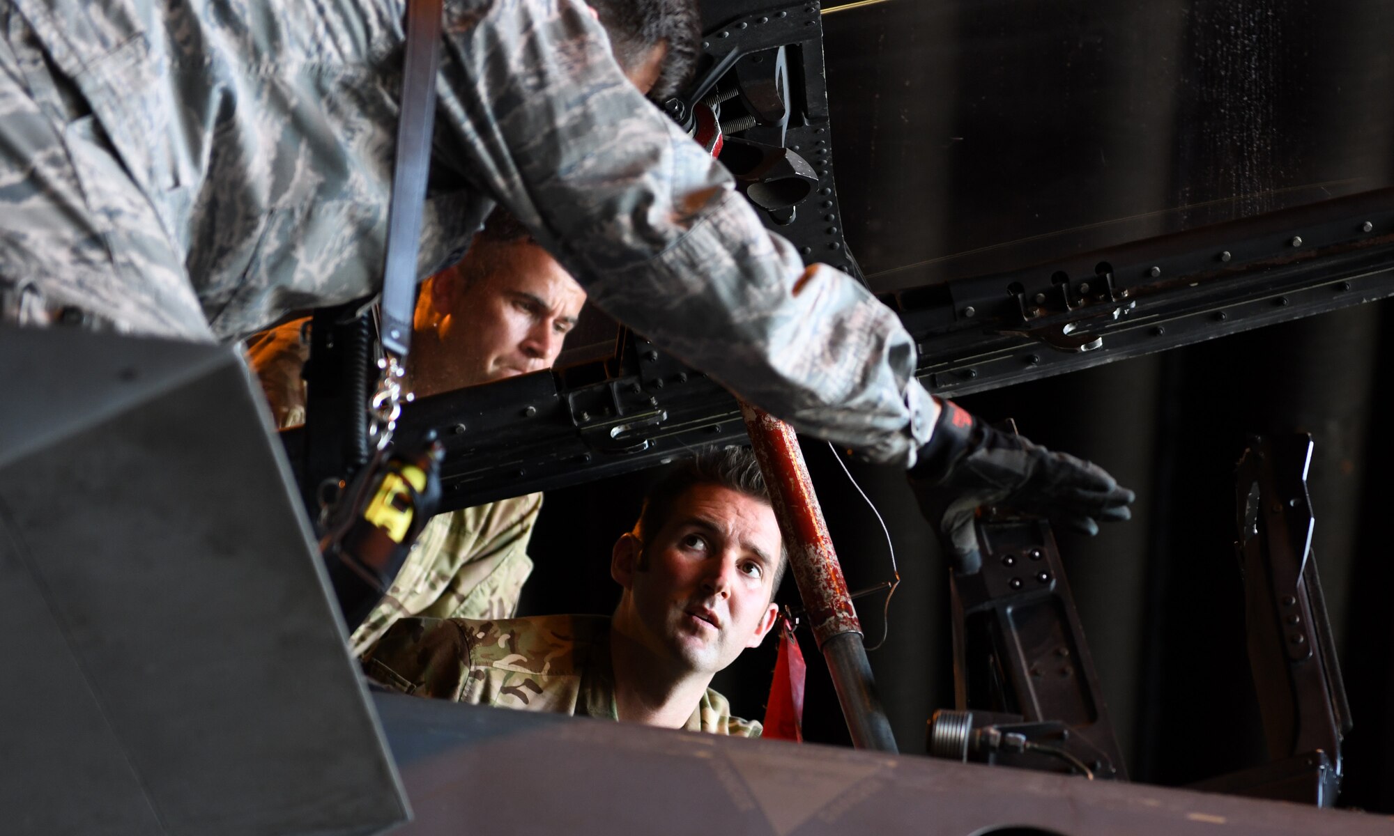U.S. Air Force Tech. Sgt. Andrew Kehoe, 48th Civil Engineer Squadron NCO in-charge of training, explains different components of an F-15E Strike Eagle cockpit to Royal Air Force Waddington personnel at Royal Air Force Lakenheath, England, July 25, 2019. Eight Fire Service members from RAF Waddington visited the base to learn firsthand the procedures, protocols, hazards and risks associated with taking care of an emergency involving an F-15 from their U.S. counterparts. (U.S. Air Force photo by Staff Sgt. Alex Fox Echols III)