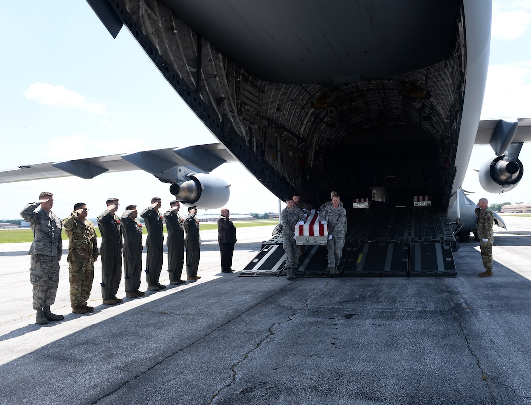 A team of Offutt Honor Guardsmen transport a casket containing the remains of a World War II service member from a C-17 Globemaster III to a truck for transportation to the Defense POW/MIA Accounting Agency here during a dignified transfer July 23, 2019. For additional images of the transfer, visit https://www.flickr.com/photos/offutt_afb/albums/72157709886860852