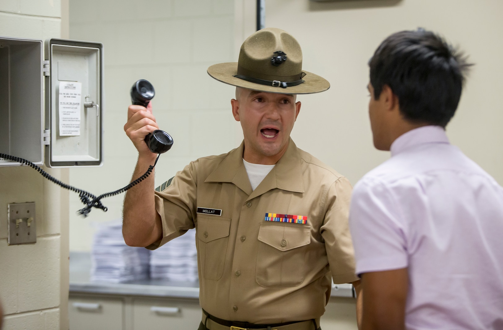 The new recruits make a scripted phone call home to inform their next of kin that they have arrived safely at Parris Island, S.C. The receiving process includes the recruit’s phone call home, gear issue, and haircuts. (U.S. Marine Corps photo by Pfc. Michelle Brudnicki)