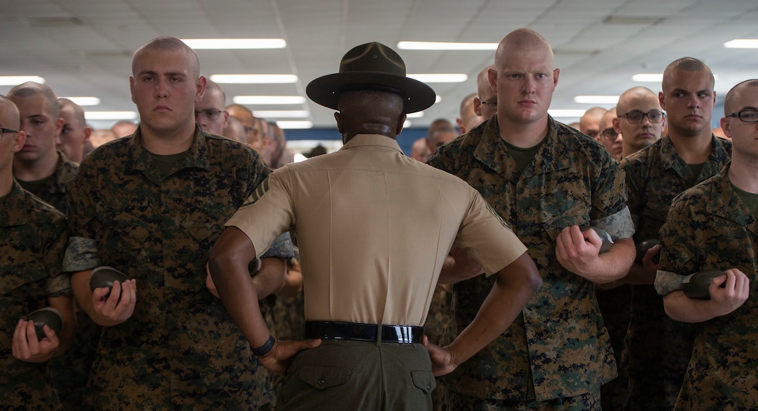 Senior Drill Instructor Staff Sgt. Keon Pondexter, 3rd Recruit Training Battalion, commands his recruits on Marine Corps Recruit Depot Parris Island, S.C. July 19, 2019. The formation Pondexter is putting the recruits in is how they will line up every time he has a mentoring session with them. (U.S. Marine Corps photo by Pfc. Michelle Brudnicki)