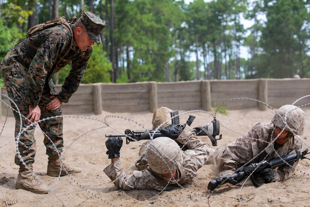 Staff Sgt. Jake Bohan, a drill instructor with Fox Company, 2nd Recruit Training Battalion motivates recruits as they make their way through the Day Movement Course July 19, 2019 at Marine Corps Recruit Depot Parris Island. The Day Movement course tests recruits ability to maneuver as a fireteam under simulated combat conditions.