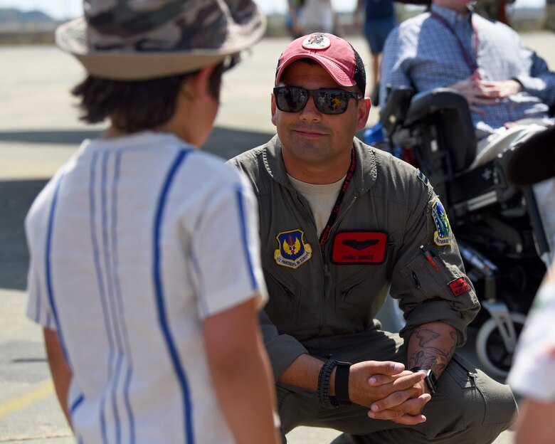 A 494th Fighter Squadron pilot talks to a young boy during Royal Air Force Marham’s annual Friends and Family Day July 25, 2019. The 48th Fighter Wing also provided two F-15E Strike Eagles and aircrews to engage with the community alongside their RAF counterparts. (U.S. Air Force photo by Airman 1st Class Madeline Herzog)