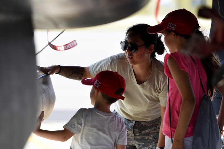 A 48th Fighter Wing Airman shows children the F-15E Strike Eagle at Royal Air Force Marham’s annual Friends and Families Day July 25, 2019. The 48th Fighter Wing also provided two F-15E Strike Eagles and aircrews to engage with the community alongside their RAF counterparts. (U.S. Air Force photo by Airman 1st Class Madeline Herzog)