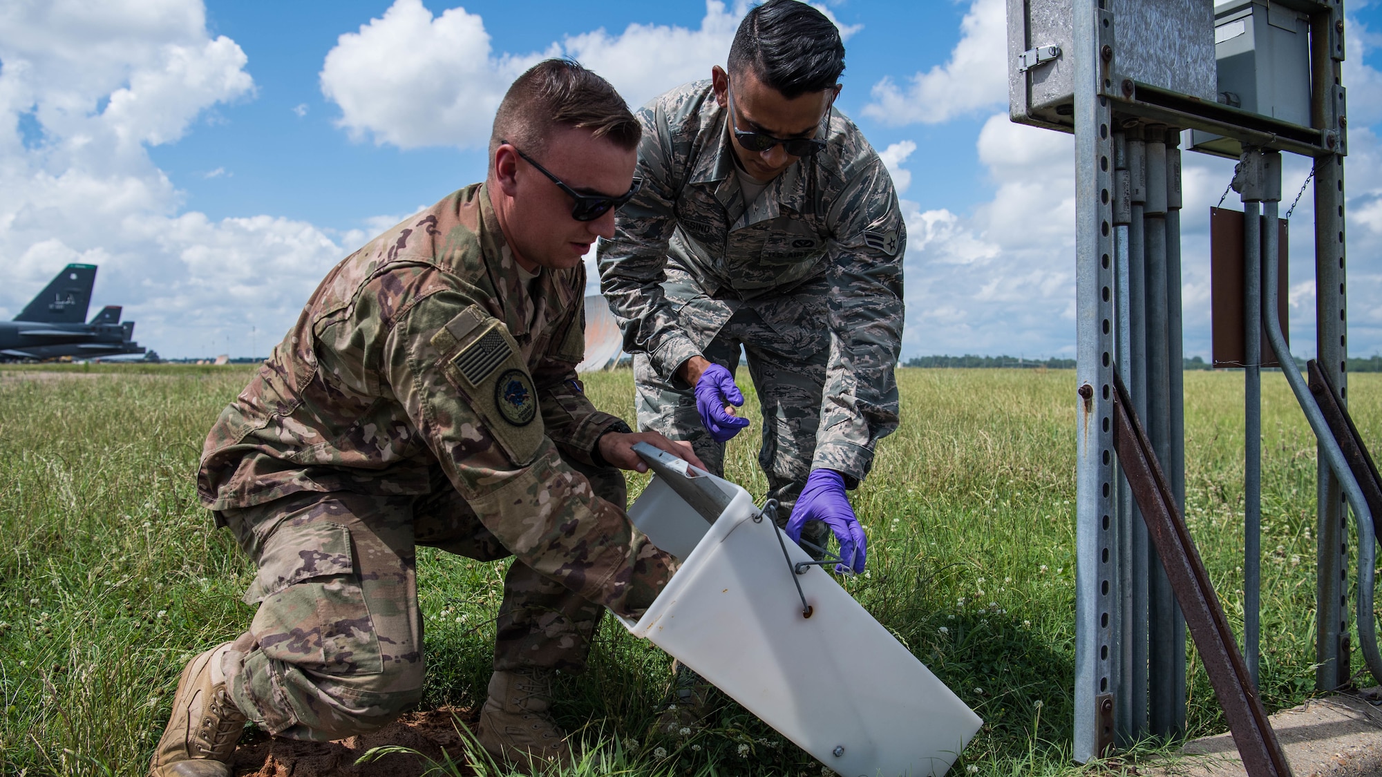 Staff Sgt. Christopher T. Cooper, 2nd Civil Engineer Squadron pest management journeyman, and Airman 1st Class Alberto Montesino (right), a 2nd CES pest management apprentice, set a skunk trap at Barksdale Air Force Base, Louisiana, June 6, 2019. Dealing with pests ranging from mosquitoes to wild dogs, the 2nd CES Ppest Mmanagement shop works to ensure no disease, injury or obstruction can hinder the safety of the mission, Airmen and their families. (U.S. Air Force photo by Airman Jacob B. Wrightsman)