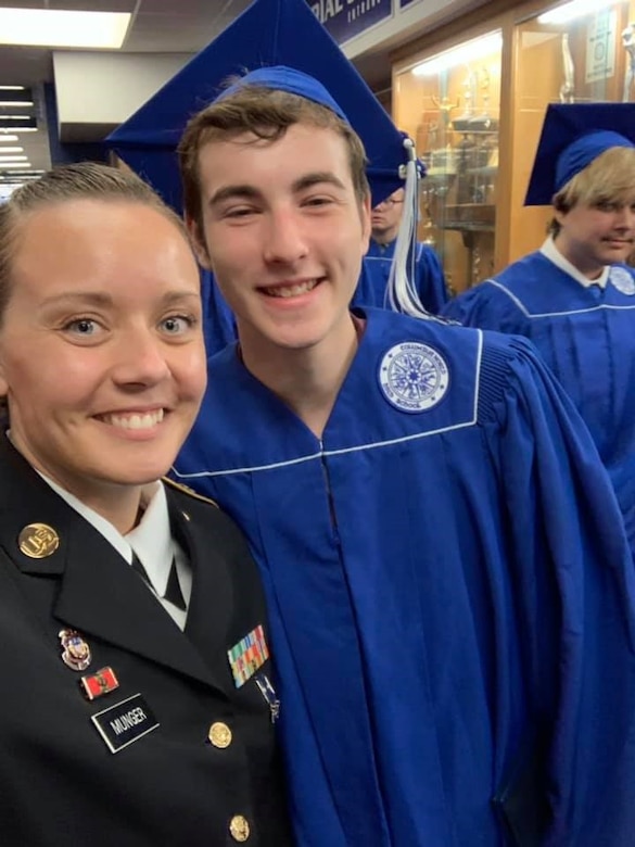 AGR Recruiter Staff Sgt. Ashley Munger, Shelbyville Recruiting Center in Shelbyville, Indiana, congratulates one of her Future Soldiers at his high school graduation..