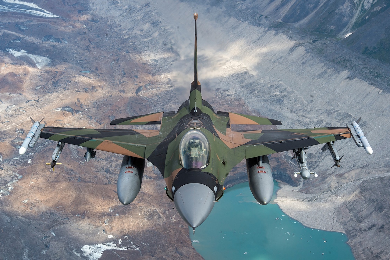 An aircraft ascends over a training area.