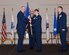 U.S. Air Force Maj. Gen. John R. Gordy II, Joint Base McGuire-Dix-Lakehurst Expeditionary Center commander, passes the guidon to Col. Bridget Gigliotti, who assumed command of Joint Base MDL and the 87th Air Base Wing, Joint Base MDL, New Jersey, July 26, 2019. Gigliotti comes from Air Mobility Command, Scott Air Force Base, where she was the Director of Manpower, Personnel and Services. Prior to that, she was stationed at Joint Base San Antonio-Lackland, Texas, where she was the 37th Training Group commander. (U.S. Air Force photo by Airman 1st Class Ariel Owings)