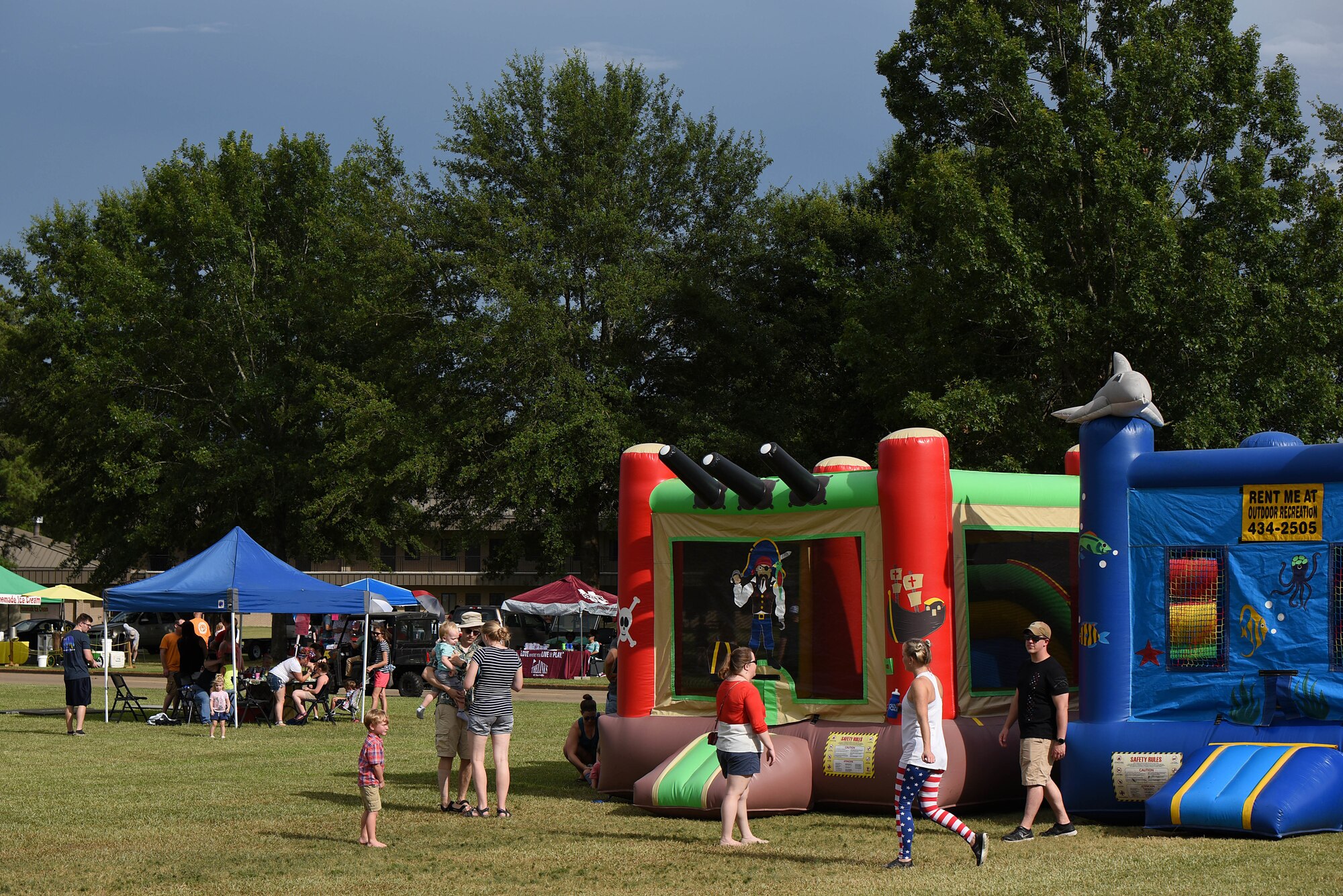 Attendees visit various attractions during BLAZE Fest July 3, 2019, on Columbus Air Force Base, Miss. The festival had an assortment of food vendors, bouncy castles and mechanical rides for children, outdoor games and so much more. (U.S. Air Force photo by Senior Airman Keith Holcomb)