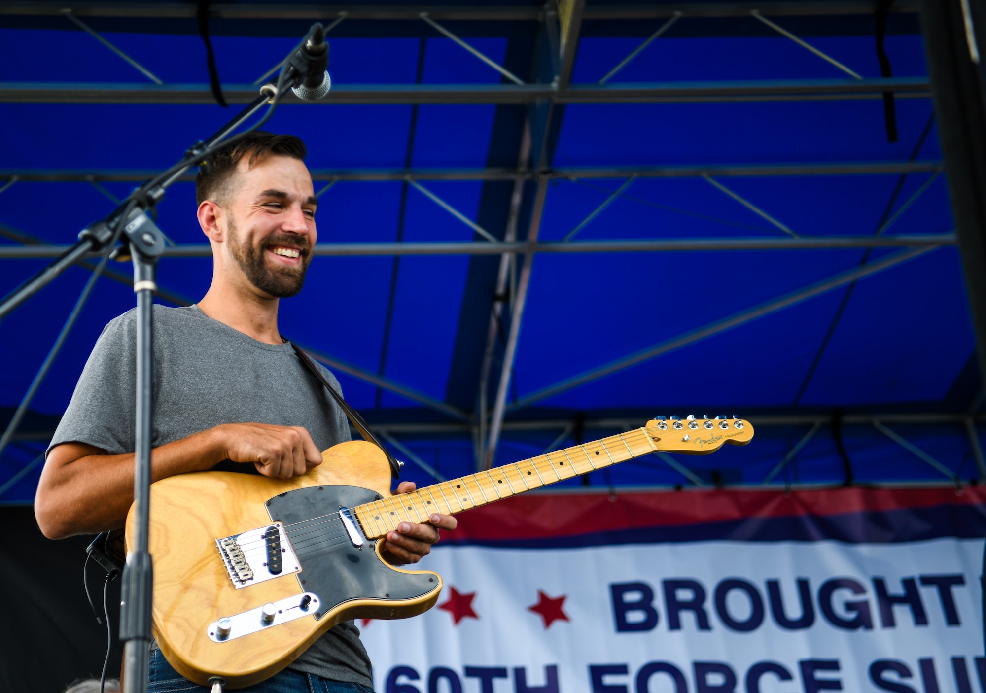 A guitarist for a Ryan Daniel band warms up before performing at Fun Fest, July 25, 2019 on Buckley Air Force Base, Colo. Various agencies and partners sponsored Fun Fest, providing service members and families with free food, music, and over 50 different games and activities to enjoy. (U.S. Air Force photo by Airman 1st Class Michael D. Mathews)