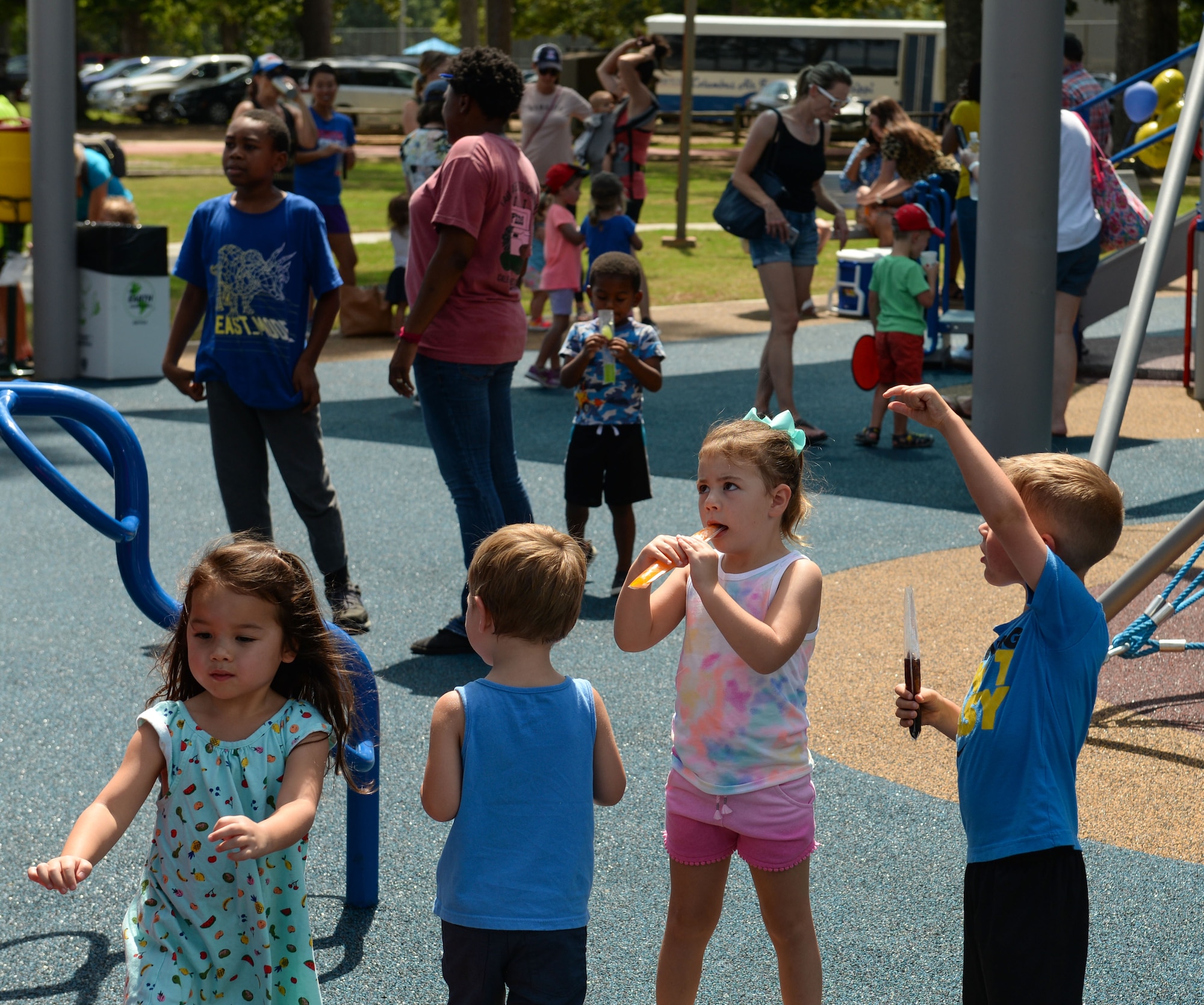 Children play on the Freedom Park playground and enjoy their popsicles July 19, 2019, on Columbus Air Force Base Miss. A ribbon-cutting ceremony was held to celebrate its completion and to commemorate the old playground. (U.S. Air Force photo by Airman Davis Donaldson)