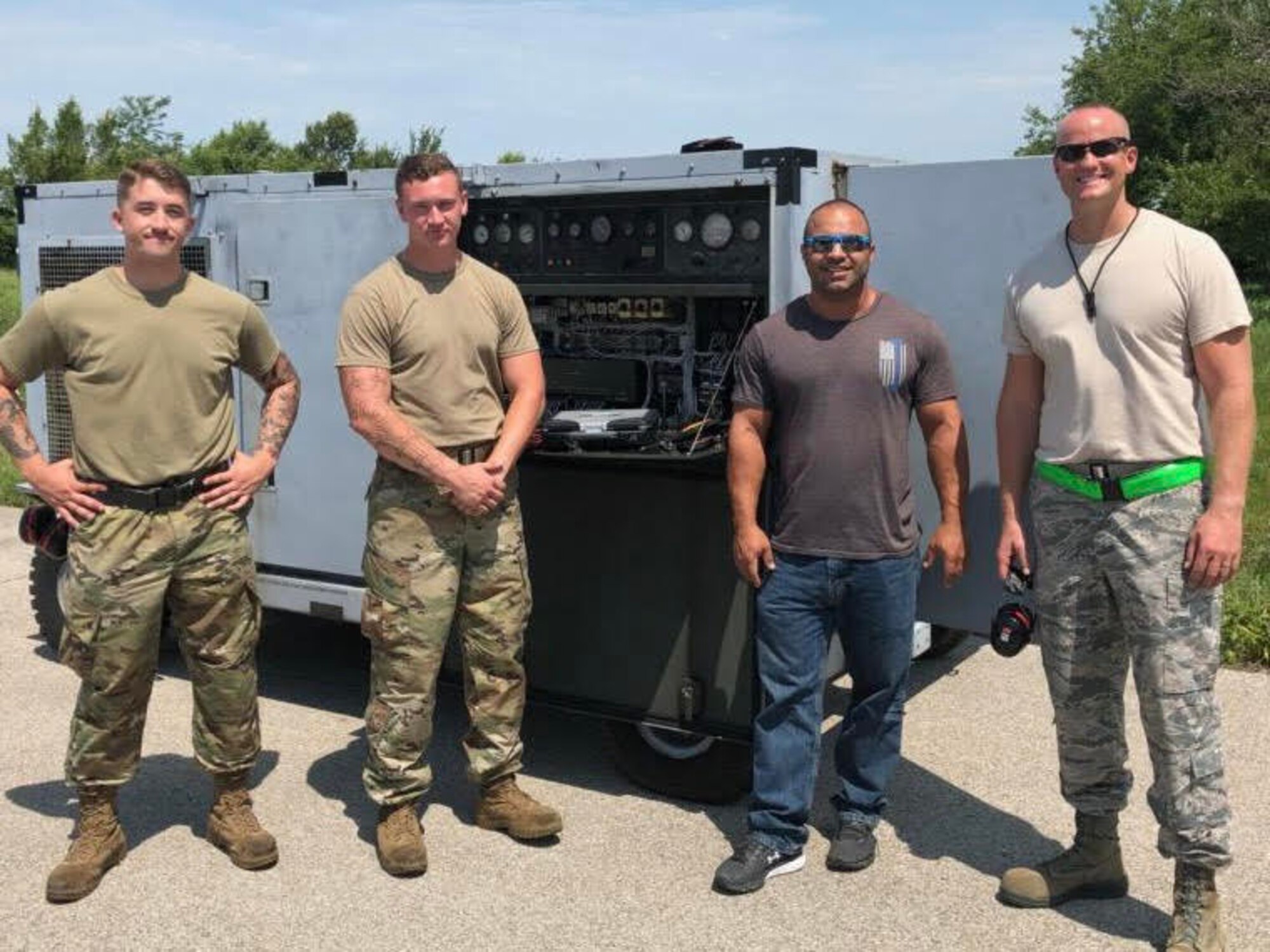 Airmen 1st Class Logan Peters and Devin Julia, Ashkan Serat and Master Sgt. Jeremy Longo, pose for a photo on July 18, 2019. They served as part of a multi-organizational team that spent a week testing potential HVAC replacement units at Whiteman Air Force Base, Missouri. (Courtesy photo)