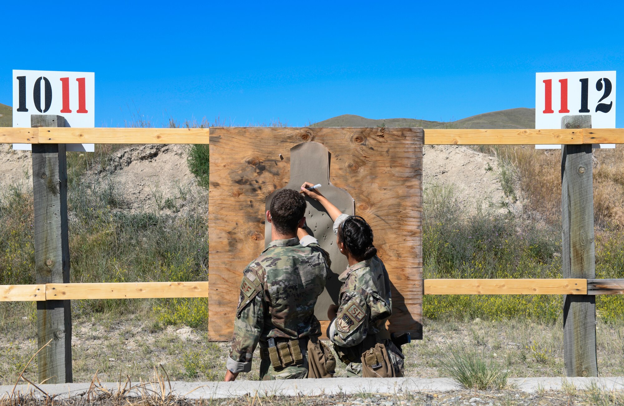 Senior Airman Kavan Cooper and Airman 1st Class Victoria Kelly, members of the 341st Security Forces Group Global Strike Challenge team, check a target July 24, 2019, at Fort Harrison, Mont.